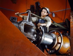 June 1942. Tightening a nut on a guide vane servomotor in the Tennessee Valley Authority hydroelectric plant at the Watts Bar Dam. View full size. 4x5 Kodachrome transparency by Alfred Palmer, Office of War Information.