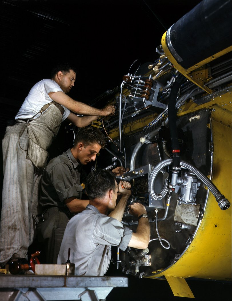 July 1942. "Wiring a junction box on the firewall for the right engine of a B-25 bomber at the North American Aviation plant in Inglewood, California. Forward of this wall will be mounted one of two 1,700-horsepower Wright Whirlwind engines." 4x5 Kodachrome transparency by Alfred Palmer. View full size.
