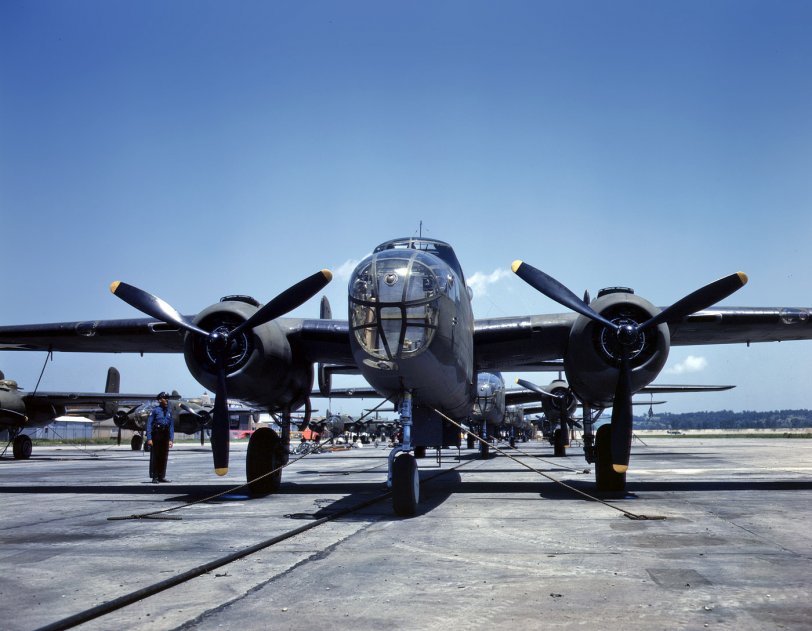 B-25 bombers on the outdoor assembly line at North American Aviation, almost ready for their first test flight. Kansas City, Kansas. October 1942. View full size. 5x4 Kodachrome transparency by Alfred Palmer for the OWI.