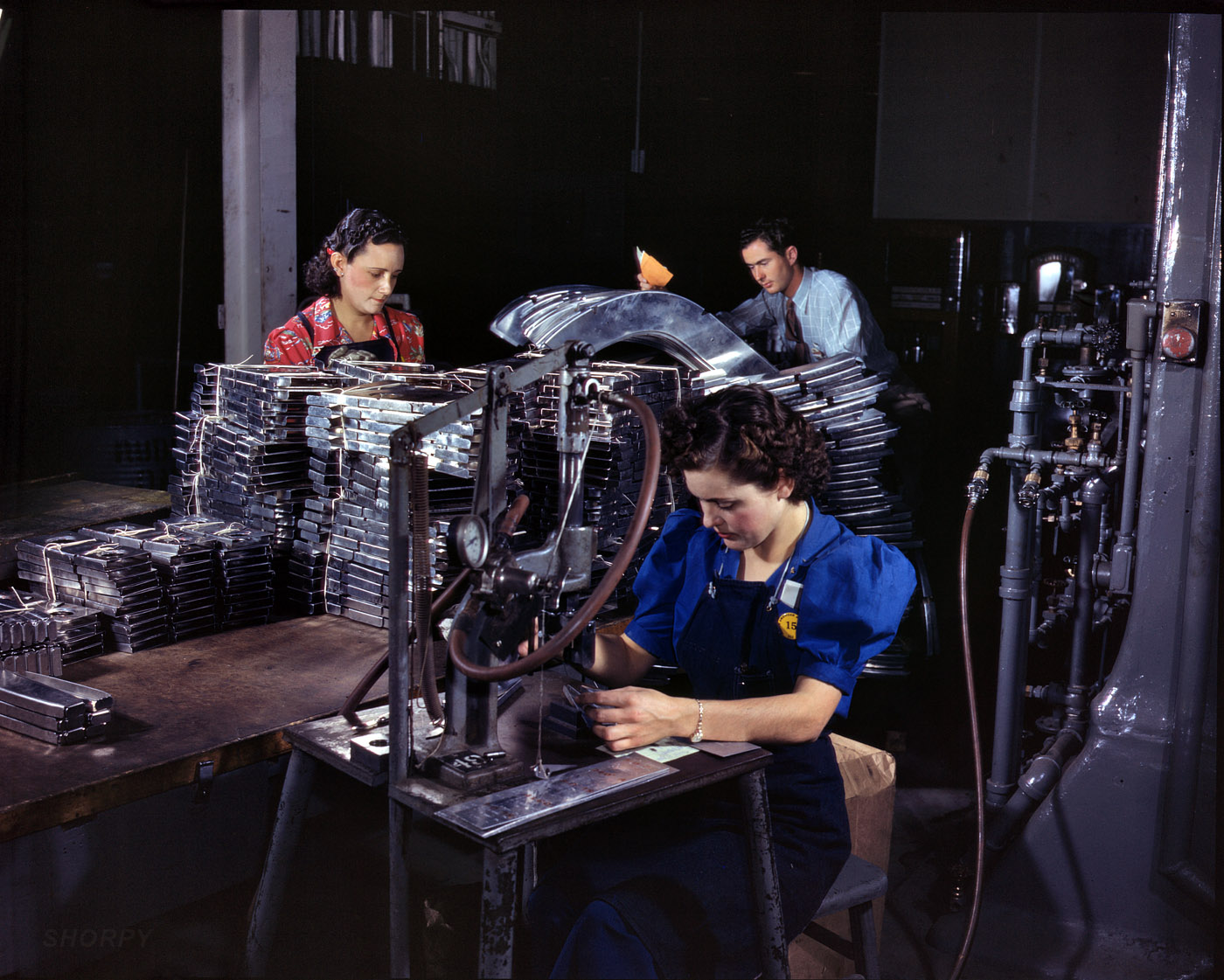 October 1942. Inglewood, Calif. "Parts are marked with this pneumatic numbering machine in North American Aviation's sheet metal department." 4x5 Kodachrome transparency by Alfred Palmer, Office of War Information. View full size.
