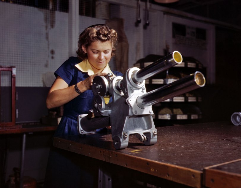 October 1942. Inglewood, California. "Young woman employee of North American Aviation working over the landing gear mechanism of a P-51 fighter plane." View full size. 4x5 Kodachrome transparency by Alfred Palmer.