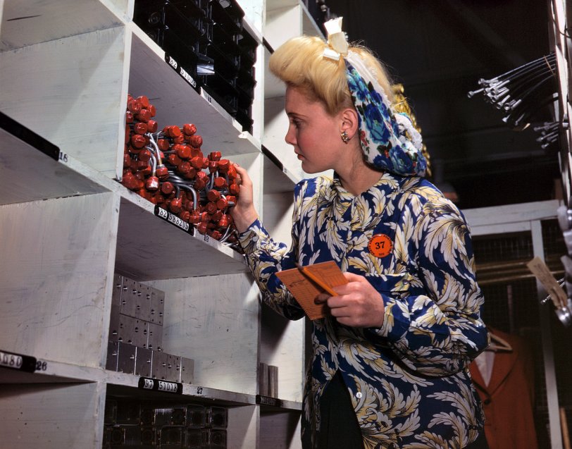 October 1942. "Clerk in North American Aviation stockroom, checking to see if the proper numbers of parts were received and placed in the proper bin. Inglewood, California. This plant produces the battle-tested B-25 (Billy Mitchell) bomber, used in General Doolittle's raid on Tokyo, and the P-51 (Mustang) fighter plane which was first brought into prominence by the British raid on Dieppe." View full size. 4x5 Kodachrome transparency by Alfred Palmer.
