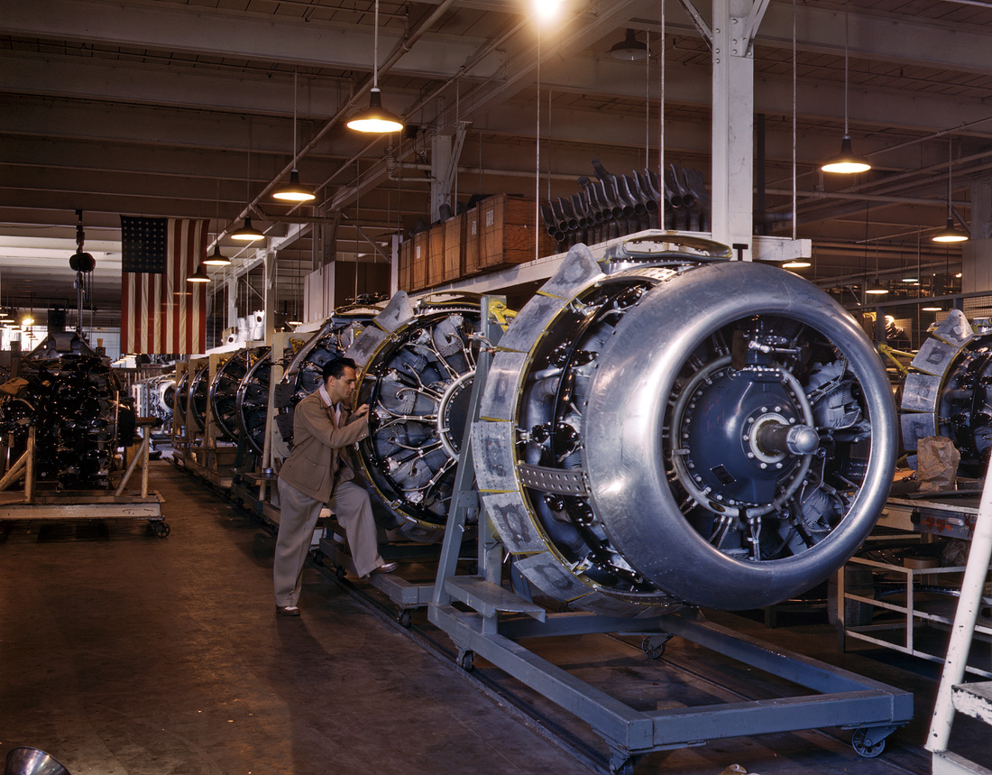 October 1942. Cowling and control rods are added to motors for B-25 bombers as they move down the assembly line at North American Aviation, Inglewood, Calif. View full size. 4x5 Kodachrome transparency by Alfred Palmer.