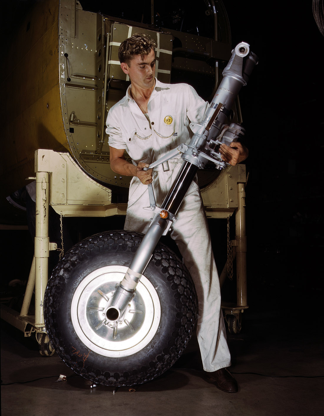 October 1942. B-25 bomber nose wheel and landing gear assembly at the North American Aviation plant in Inglewood, California. View full size. 4x5 Kodachrome transparency by Alfred Palmer for the Office of War Information.
