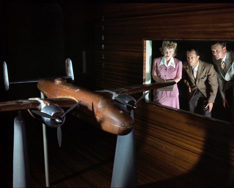 October 1942. Experimental staff at the North American Aviation plant in Ingle- wood, Calif., observing wind tunnel tests on a model of the B-25 ("Billy Mitchell") bomber. View full size. 4x5 Kodachrome transparency by Alfred Palmer.