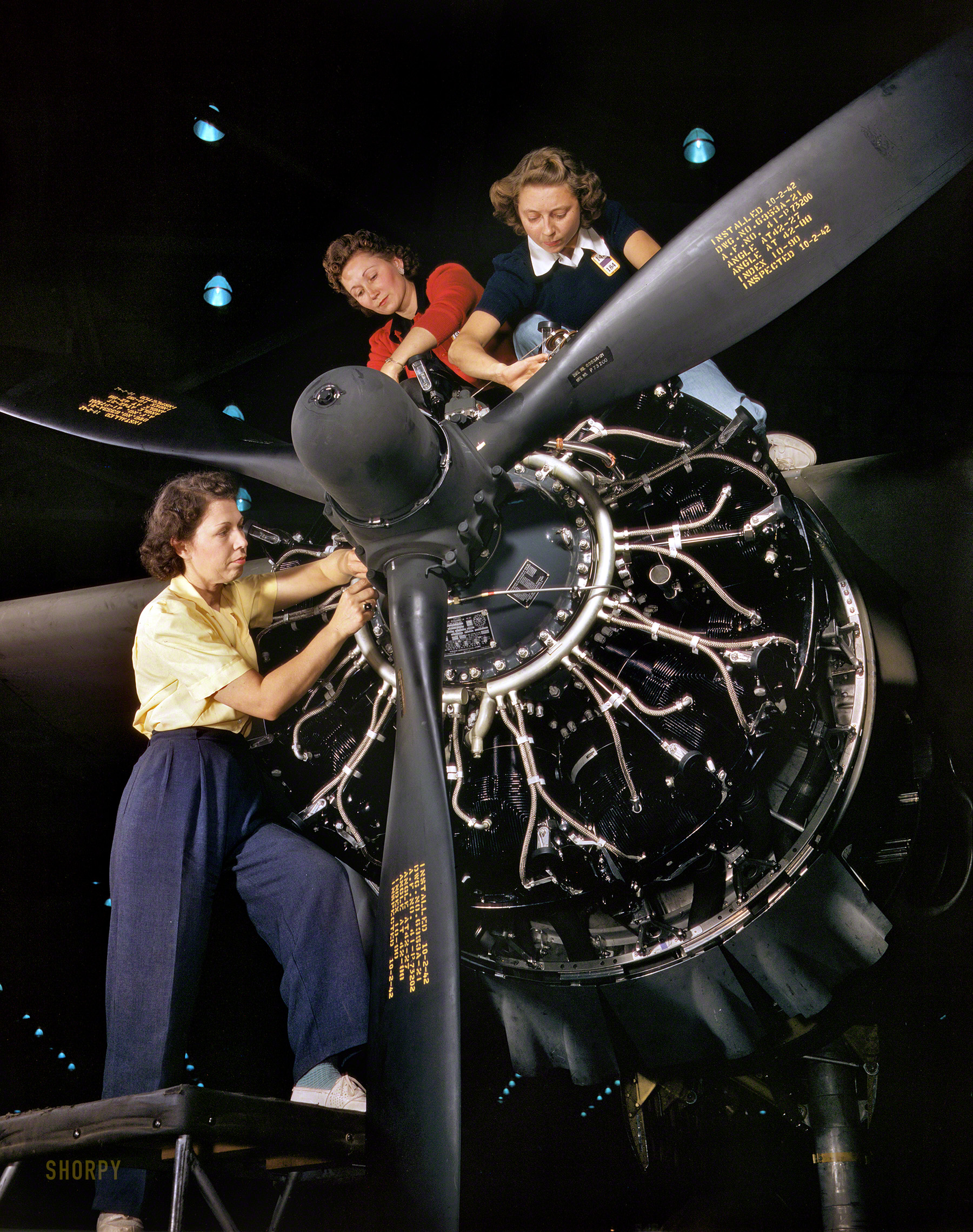 October 1942. "The careful hands of women are trained in precise aircraft engine installation duties at Douglas Aircraft Company, Long Beach, Calif." Kodachrome by Alfred Palmer, Office of War Information. View full size.