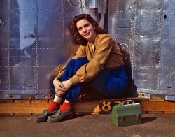 October 1942. "Noontime rest for an assembly worker at the Long Beach, Calif., plant of Douglas Aircraft Company. Nacelle parts for a heavy bomber form the background." View full size. 4x5 Kodachrome transparency by Alfred Palmer.
Is that...the same girl as in the picture titled "Madonna of the sandbags"?
[It is indeed. - Dave]
The SocksAnd I love the red socks! The perfect touch for the photo, just like Nat'l Geographic used to do (still does?), a bit of red in every image.
WowAfter all the comments on differing ideas of feminine beauty, this picture is a stunner!  You ought to put it in the pretty girls gallery.
The coloursThe vibrancy of the colours in this picture are an advertisement for Kodachrome, even if there's been work done  on them. The vibrancy of the blues and the reds, not to mention the colour of her blouse - absolutely stunning. And she ain't bad either - every time you run one of these pictures of women war workers I end up falling in love with women who were born before my 78-year-old mother.
I&#039;ll second that"every time you run one of these pictures of women war workers I end up falling in love with women who were born before my 78-year-old mother."
Absolutely. These womenfolk are examples of true, timeless beauty.
Amazing ClarityAlthough everyone rightly raves about the colors from these old Kodachromes, what amazes me is the absolute clarity of the pictures even when viewed full size.  This is an aspect of the large format (4x5) combined with, I'm sure, some very expensive glass.  I can't even imagine what the megapixel equivalent would be, if you could even get this clarity with a digital camera.
(The Gallery, Kodachromes, Alfred Palmer, Pretty Girls, WW2)