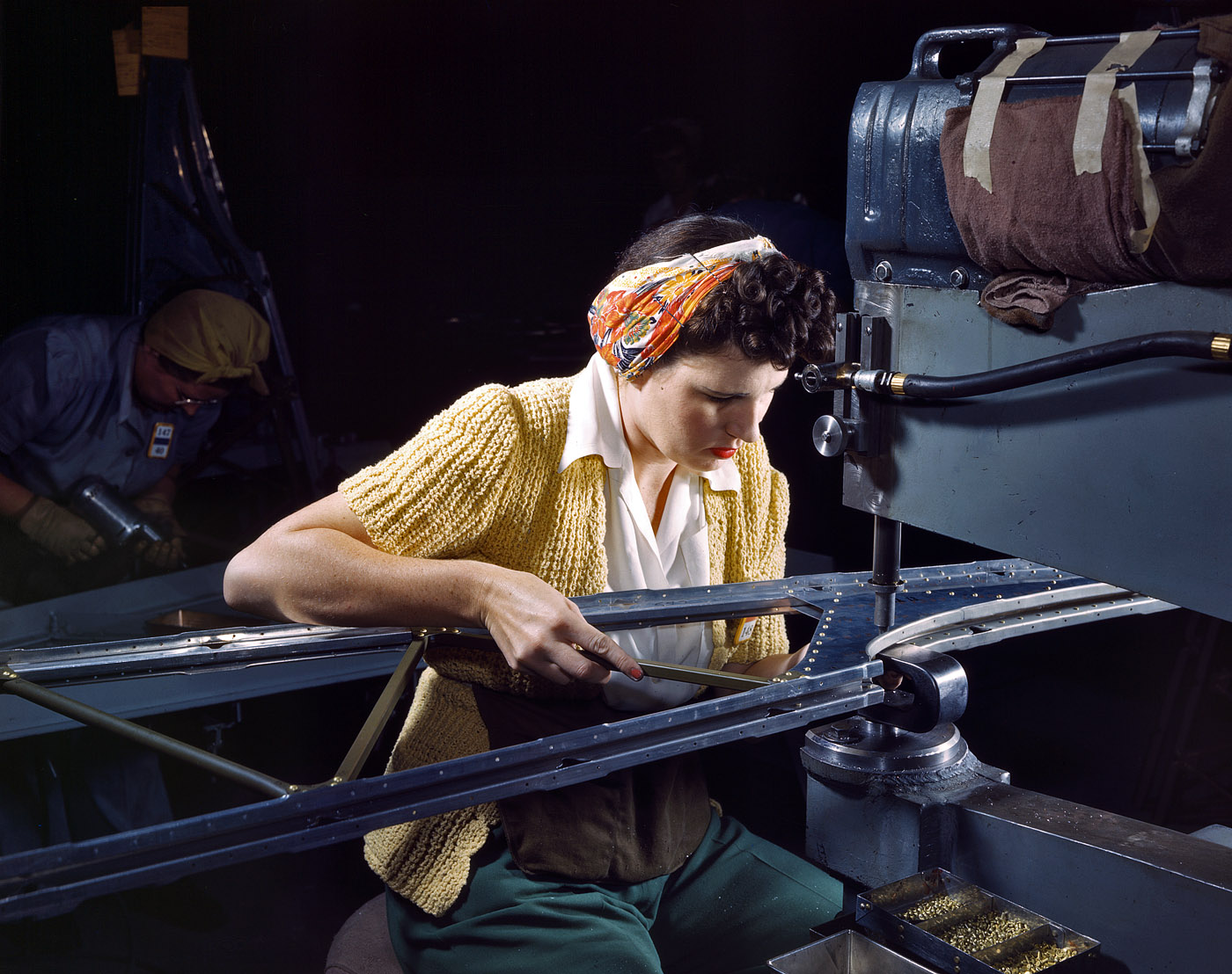 October 1942. Long Beach, California. "Girl riveting machine operator at the Douglas Aircraft Company plant joins sections of wing ribs to reinforce the inner wing assemblies of B-17F heavy bombers." View full size. 4x5 Kodachrome transparency by Alfred Palmer for the Office of War Information.
