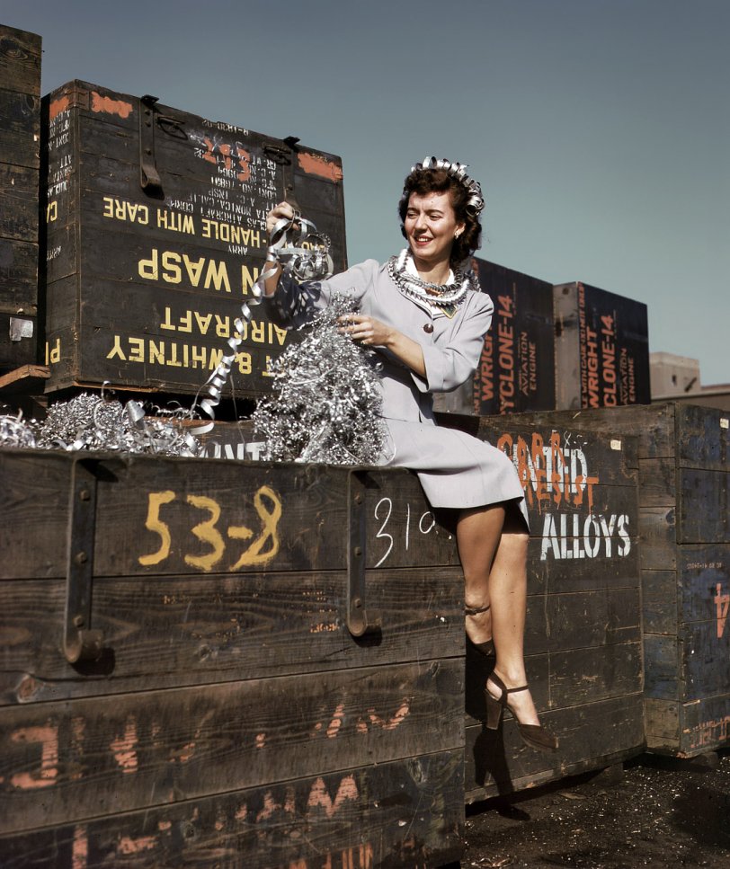 Long Beach, California. October 1942. "Annette del Sur publicizing salvage campaign in yard of Douglas Aircraft Company." View full size. 4x5 Kodachrome transparency by Alfred Palmer for the Office of War Information.
