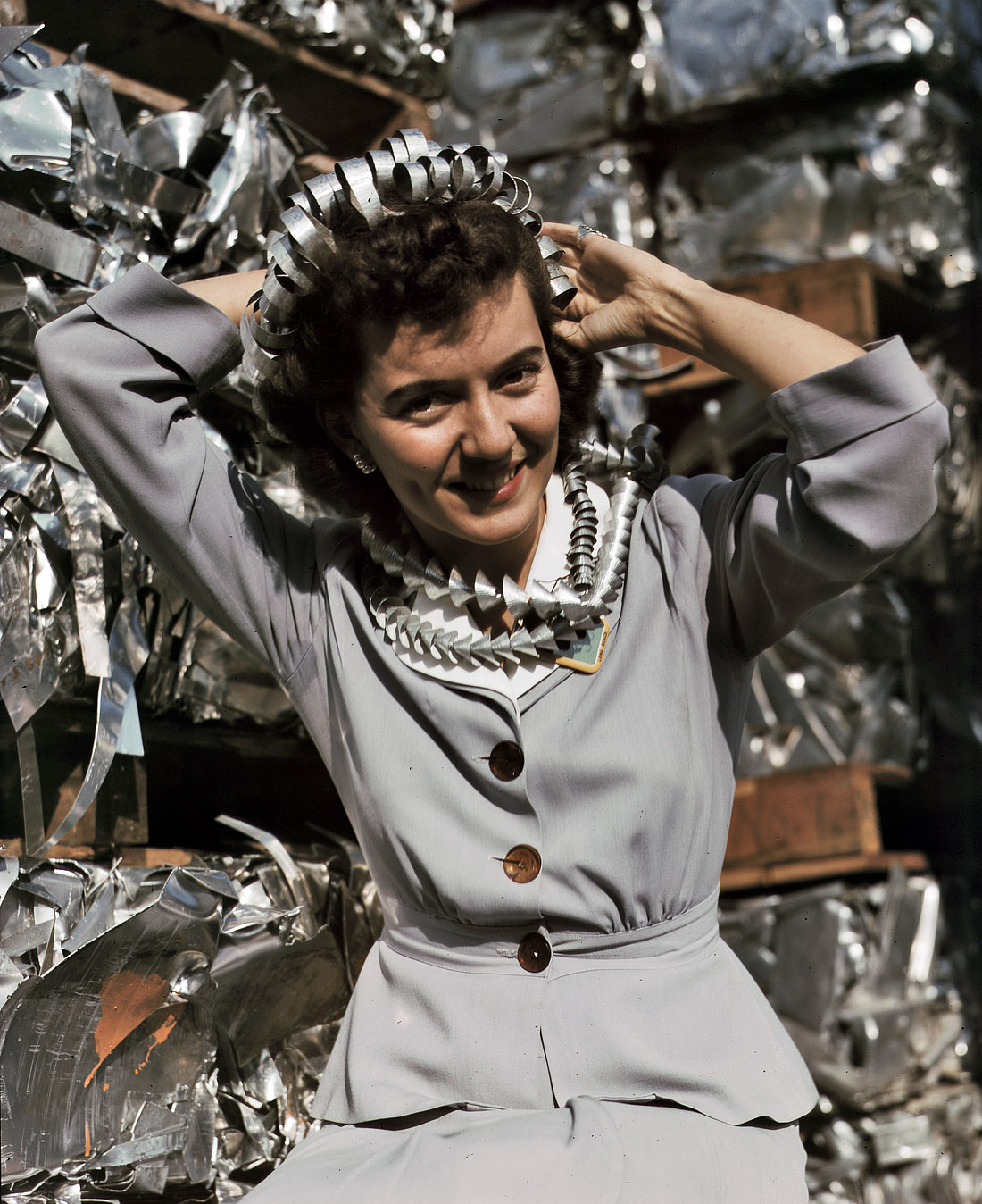 October 1942. "Office employee Annette del Sur publicizing salvage campaign in yard of Douglas Aircraft Company, Long Beach, California. The earrings and hair ornaments are fashioned from aluminum turnings." View full size. 4x5 Kodachrome transparency by Alfred Palmer for the Office of War Information.