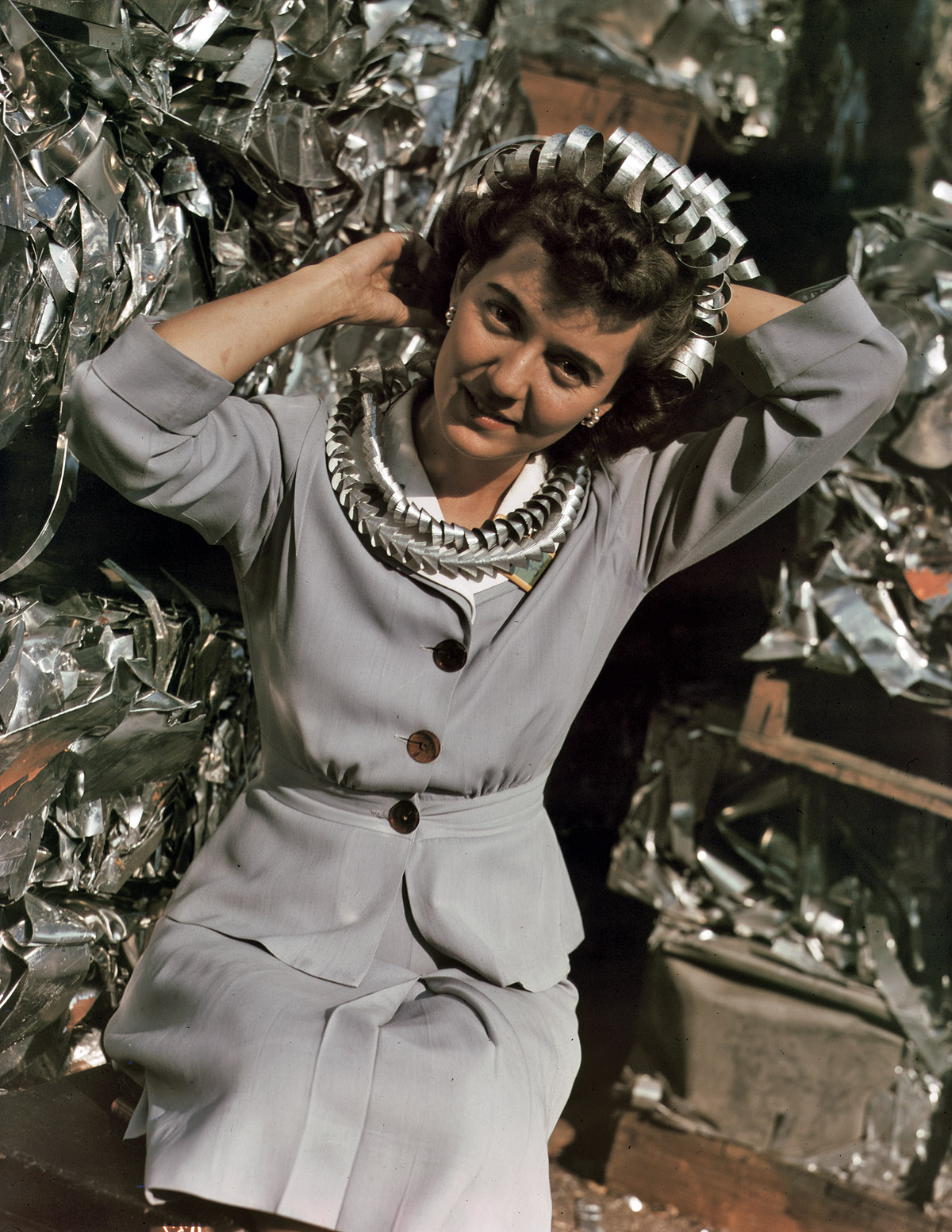 October 1942. "Salvage queen Annette del Sur, an office employee at Douglas Aircraft, Long Beach, California, with aluminum scraps collected at the plant." 4x5 Kodachrome transparency by Alfred Palmer. View full size.
