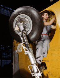 February 1943. Readying a "Vengeance" dive bomber for landing gear installation at Consolidated-Vultee, Nashville. View full size. 4x5 Kodachrome transparency by Alfred Palmer. 