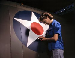 Touching up the U.S. Army Air Forces insignia on a "Vengeance" dive bomber manufactured at Consolidated-Vultee's Nashville division. February 1943. View full size. 4x5 Kodachrome transparency by Alfred Palmer.