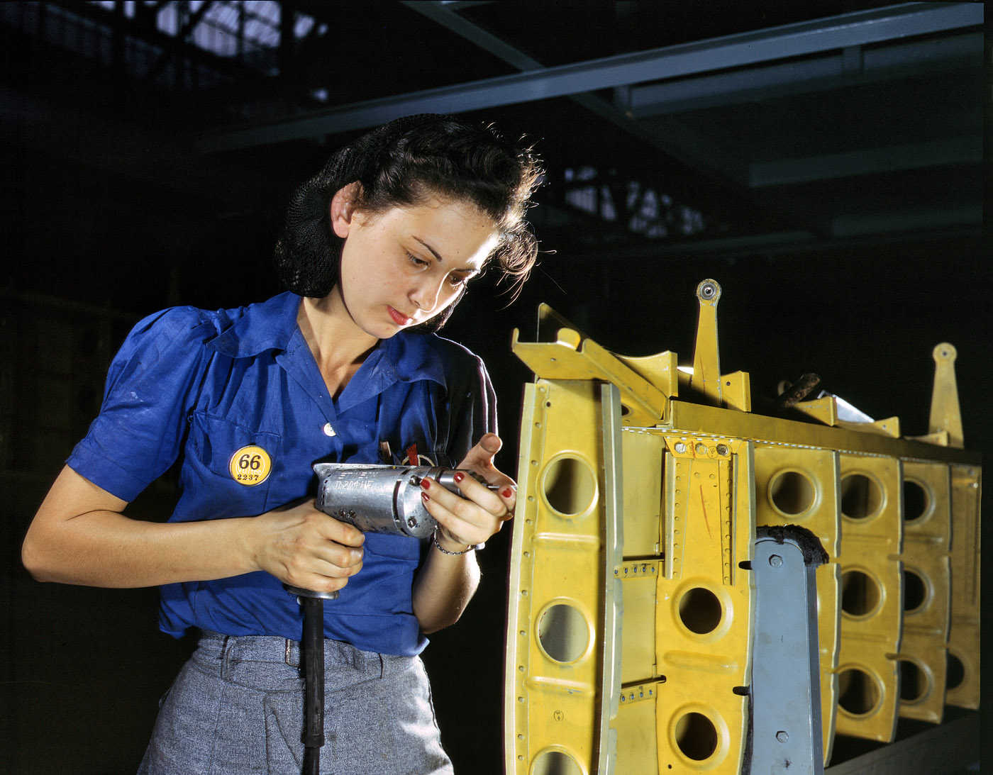 February 1943. Working on the horizontal stabilizer of a "Vengeance" dive bomber at the Consolidated-Vultee plant in Nashville. View full size. 4x5 Kodachrome transparency by Alfred Palmer for the Office of War Information.