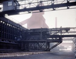 November 1942. "Hanna furnaces of the Great Lakes Steel Corp., Detroit. Coal pusher apparatus with coal storage building seen in the fog which constantly hangs over the plant." 4x5 Kodachrome transparency by Arthur Siegel. View full size.