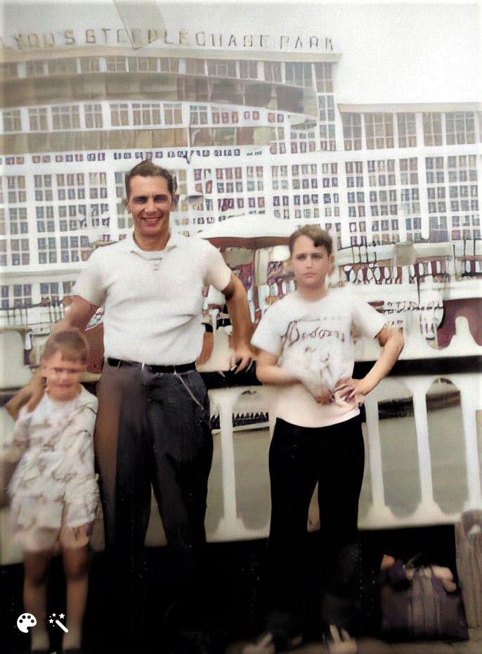 Photo taken on the boardwalk of  Coney Island  around July, 1948 by my mother on a family outing  from the Bronx. The Dodgers were still in Brooklyn and Steeplechase park was  one of the most creative and exciting amusement park rides of its day.

Dad was a milk truck driver for Sheffield Farms Dairy one of the earliest suppliers of hygienically  sold milk in the city. His "trucker's wallet" on a pocket chain was part of men's wardrobe in the day.  

Steeplechase park included many fun family attractions including  a gravity-powered ride in which people raced each other while riding wooden horses that glided along parallel metal tracks over a long and curving course.  I was too little to ride what  was considered a bit dangerous adventure. An entire family could spend the day at Steeplechase, picnicking and walking through the gardens.  Of course, they'd also likely end up splurging on a few of Steeplechase's carnival games or other rides not included in the combination ticket.   

Steeplechase park opened for the 1897 season and was an immediate success.  Tilyou's park was more than just a collection of rides.  He had well-maintained gardens and benches and areas where families could picnic.  Bands played it  closed in 1964.