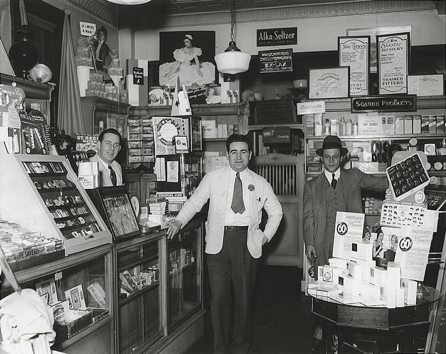 Photo taken Peekskill, NY (Family photo Katrina Murray collection)

DeChristopher's Pharmacy never really changed in all the years. The candy display that was always on the side, lighters and cigars on the case on the left. Pharmacy section at the back. This was the only pharmacy where you could buy chemicals to do science class (and out of class) experiments in the sixties and seventies. Notions and whatnots, Zippo lighter flints, Ronson  lighter fluid, Dr Grabos pipes, rubber goods, wrist watches, Westclocks Baby Ben alarm clocks,  Evening in Paris Perfume. Lifesavers candy counter, Smith Brothers cough drops. View full size.