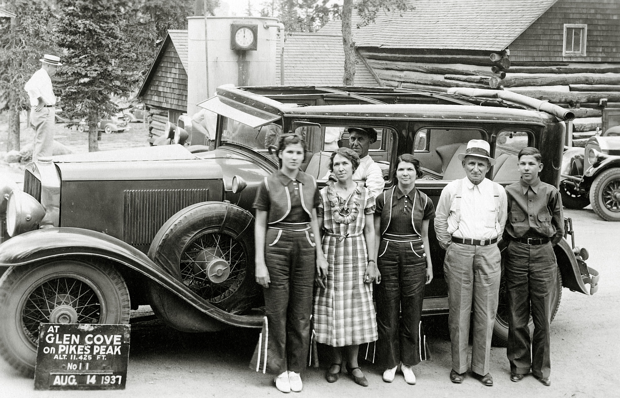 Taken near Pike's Peak, Colorado, my great grandfather's brother, George W. Downing, poses with his wife, family,  and one great automobile. View full size.