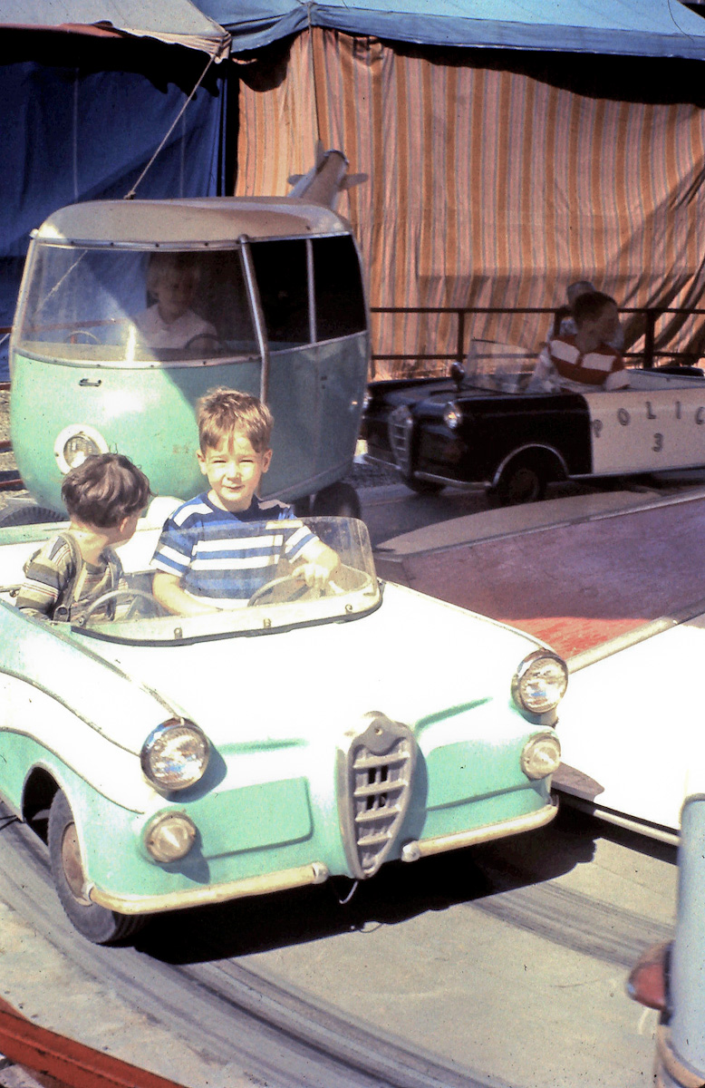 This is my brother (looking behind) and me at the Agricultural Fair in Cloverdale, BC, in August 1966. Does anybody else agree that the cars' grille looks as if it's from an Alfa Romeo? View full size.