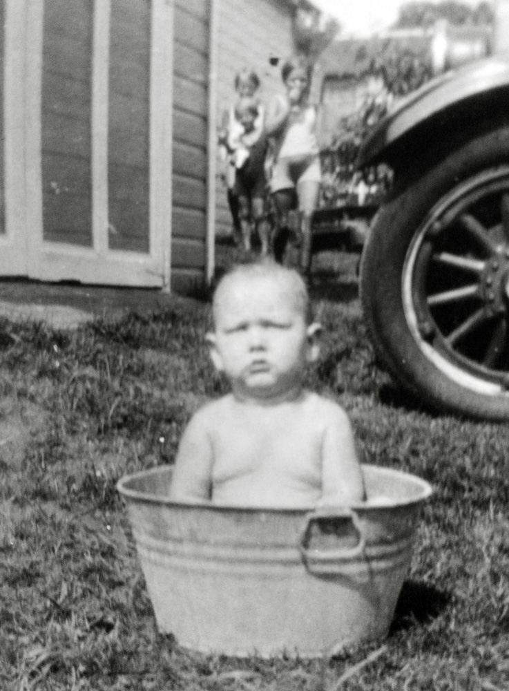 Hartford, Connecticut, 1931. As the saying goes, "Saturday is bath day whether you need it or not."  My father Walter is none too happy to be bathing.  I doubt he was aware of the little girls watching him since he had no room to move.