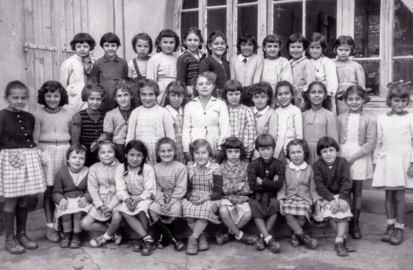 This photo was taken in France in 1952. My mother appears in the middle row. View full size.
