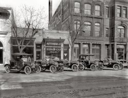 Washington, D.C., circa 1911. "Hudson cars, H.B. Leary agency, 1317½ 14th Street N.W." Harris &amp; Ewing Collection glass negative. View full size.
Keep the Cars Coming!I love the pictures of the cars! Where else can we see such detail of these cars "in period"?
Enough!How many more pictures of DC car dealerships are we going to have to suffer through?
Squeeze me.I bet kids found those horns irresistible as they walked by parked cars.
Great Scott!I looked and looked, and then my wife noticed: These are all right hand drive cars! Why???
99 years and still on the roadHere's a 1911 Hudson, snapped at a car show in Concord, North Carolina, April 10th, 2010. Its body style (touring car) is like the one visible in the storefront window. This was only the third year for Hudson production.
No Hupmobiles?Five spiffy Hudson models in a row and not one Hupmobile!  I owned a Hudson myself for over 40 years.  They were good cars (obviously).
Great historical car photographI love these vintage car photos. They are as much about our history as the architecture behind them. This photo just got copied into the Hudson folder in my digital car collection.
memo to 8:28Hey Anon at 8:28 - some of LOVE pictures of old cars.
If you're "suffering" - GO SOMEWHERE ELSE !!!!!!
What&#039;s wrong with cars?What's wrong with pictures of cars? Besides, they're neighborhood pictures. At least around here, we no longer have laundries on the scale of the Star Laundry next door. Quaker Oats isn't a surprise, but some of the store-side ads are. Some products are a lot older than you think.
Please keep to the LeftThere was no requirement for left-hand steering in those days-- but Henry Ford switched from right to left in October 1908 as his Model S gave way to the Model T, and he wound up with enough sales volume to influence the trend. By about 1914, most or all the US cars had settled on left-hand drive.
[In 1914, many if not most American cars used right-hand drive. Even in the early 1920s some manufacturers were still using RHD. - Dave]
Seriously?These dealership photos are beautiful. Americana at its finest. Keep 'em comin'.
Anyone know where Star Laundry might be?I see eight signs in this picture. Wow.
Star LaundryThe Star Laundry building is still there, relatively uncannibalized, at least above the first floor level.  At street level, it is now the La Villa Restaurant, a take-out fajitas and taco joint. The buildings on either side, including the Hudson dealership, have been "updated" beyond recognition. No way to tell if the buildings behind the faux siding are even the same as what was there in 1911. The Star building is holding up well though.
View Larger Map
My HeritageAs the scion of two generations of hand laundrymen, I understand the importance of "We mend your linen." If the customer didn't know his sheets were torn, the storekeeper took the heat. Sometimes they would be beyond repair and were returned unlaundered.
As for "Regular Pkgs 10¢" -- my grandfather opened his laundry on Market Street, on the Lower East Side, in 1910. Unfortunately, he died in 1935, so I'll probably never know if he ever got as much as a dime for a bundle of wet wash.
In any case, notwithstanding the disapproval of Automobile Dealership Americana, this is one great photo.
Left and RightEarly cars had right-hand steering because the brake lever (which was hand-operated), gearshift and horn were on the outside of the car. Since most drivers were right-handed, they had to sit on the right to reach them.
Car displayWhat I find so interesting about most of these car photos is that the cars are displayed on the street.  The businesses were storefronts rather than stand-alone car lots.  I suspect this is the case since cars were rare and most probably had to be special ordered. I wonder when the stand-alone lots became the standard mode of car sales.
Bring on the Detroit DealershipsI can't wait until you feature MORE early car dealerships. Bring 'em on!
8:28: What a Party PooperI love the old auto dealership photos. Why should 8:28 complain? There are also old buildings in the photo.
I propose that a right-hand drive auto be driven over the foot of 8:28 until a more reasonable attitude is evinced.
More HeritageMy dad was an automobile dealer all his life. I practically grew up in showrooms and used-car lots in the 1950s and 1960s.  I love these shots, keep 'em coming!
Times have changedThat Hudson dealership is now a gay bathhouse. 
(The Gallery, Cars, Trucks, Buses, D.C., Harris + Ewing)