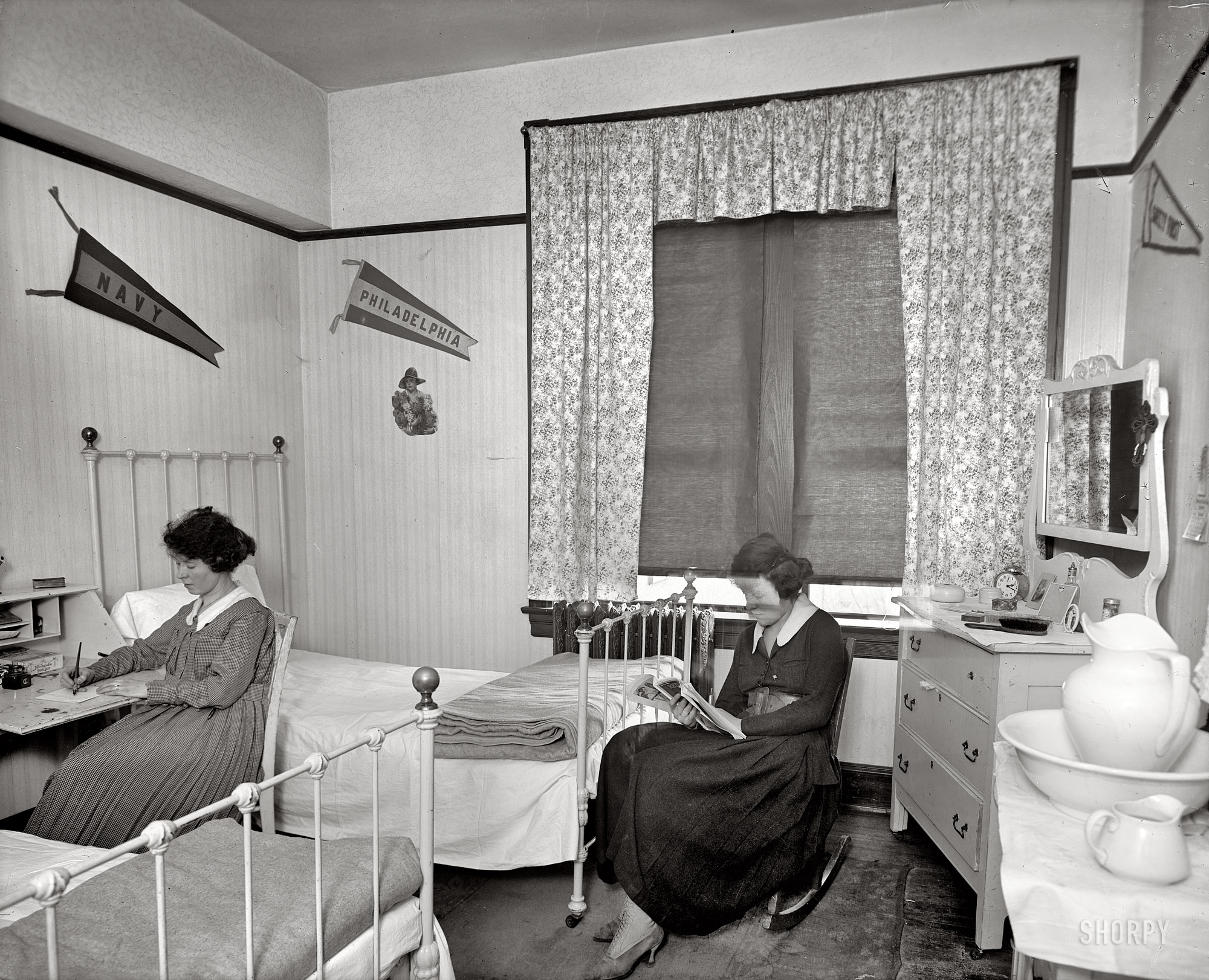 Washington, D.C., circa 1918. "Chesapeake & Potomac Telephone Co. dorm room." Being perused by Miss Double Exposure: the January 1918 issue of Red Cross magazine. Harris & Ewing Collection glass negative. View full size.