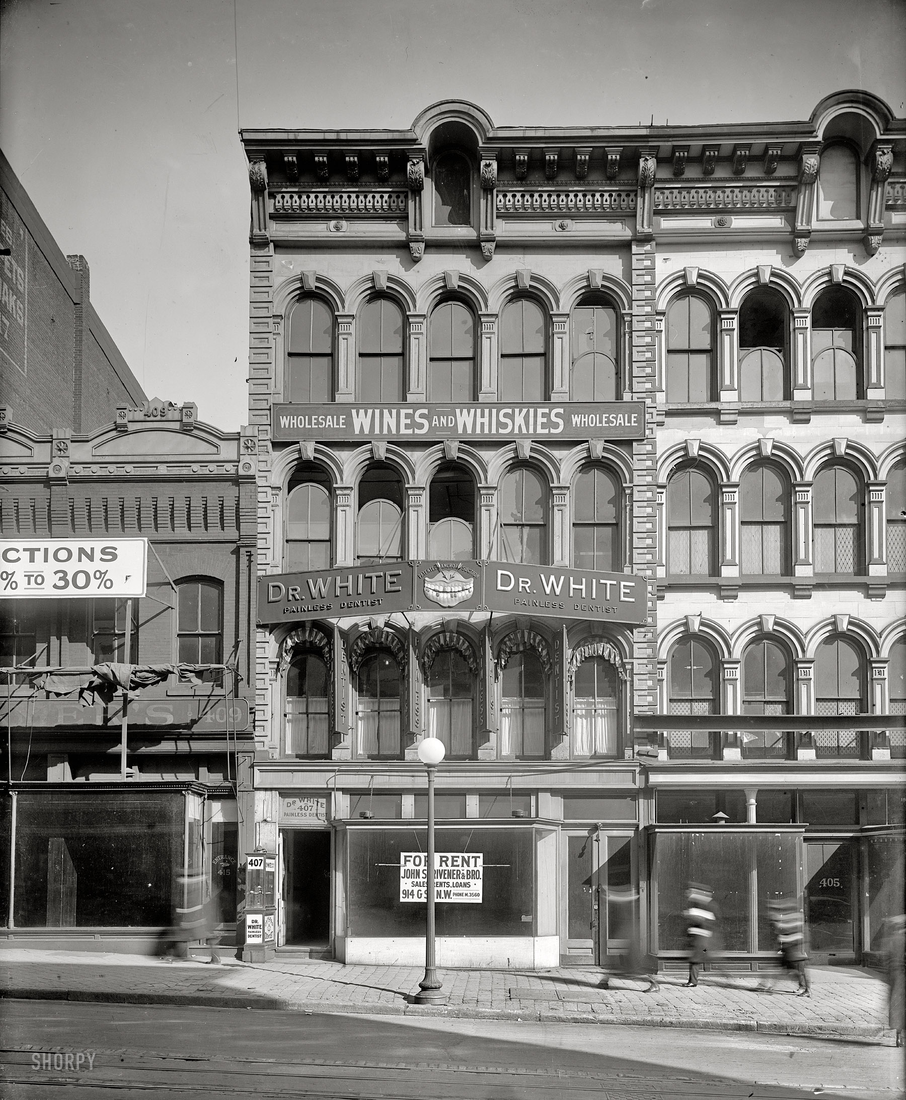 Washington, D.C., circa 1918. "Emergency Fleet Corporation, building exterior." Do streetscapes come any better than this?  An interesting juxtaposition of signs (Painless Dentist, Wines & Whiskies), and of course there's that ghastly set of rotten choppers. Harris & Ewing Collection glass negative. View full size.