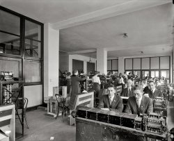 Washington, D.C., circa 1920. "Tabulating Machine Co." Our third look at the firm's equipment in action. Harris &amp; Ewing glass negative. View full size.
Thanks for jogging the memoryI worked on maintaining punched card sorters in London in my school holidays in the late 60s. The machines were just slicker versions of the ones shown here. The quantity of punched cards was staggering. The Prudential Assurance Building had 5 million punched cards laid out on tables. They in the process of being copied on to magnetic tape. Five years later I was working on "state of the art" computers. In 1973 ours had a 5MB hard disk about the size of a dustbin. It's time I went in search of all the photos I took....
Full EmploymentAll of these people have been replaced by one modern computer.  What do they do now?
What they do nowR.I.P., we hope
Lights outHave you ever noticed that in many of these circa-1920 office interior photos, the ceiling lights are rarely in use? Was electric light still enough of an innovation that its use was often an after thought, or was electricity in "them days" expensive enough that keeping the lights off was a cost-cutting measure for the bean counters? Inquiring minds want to know!
[I think a lot of the smaller ceiling fixtures were probably used only for nighttime illumination. - Dave]
Just ThinkIn 50 years people will be viewing pictures of us doing our daily tasks with pity....
Price of electricityFrom what I have been told, the average price of a kwh of electricity about that time was 65 cents, where now it averages 9 cents.  Perhaps it was too expensive then.
The tabulatorsThey are hard to identify based on Web photos, since most tabulators you see pictures of are different models. But it looks a bit like the one in this photo, albeit a view of the other side of the machine.
Notice that they added finger guards to the leather drive belt by 1934, presumably as a result of some missing fingers. 
Thonet #14Those are Thonet chairs no. 14 the "chairs of chairs" http://en.wikipedia.org/wiki/Michael_Thonet. As seen in Viennese cafes.  
Women in the workplaceInteresting there are so many women... my grandmother once told me a woman's employment choice back then was only teacher, nurse, secretary, or housewife. Not true in the big city I guess!
[I think punch-card operator would fall under the heading of clerical work, one of the traditional "women's jobs." - Dave]
(The Gallery, D.C., Harris + Ewing, The Office)