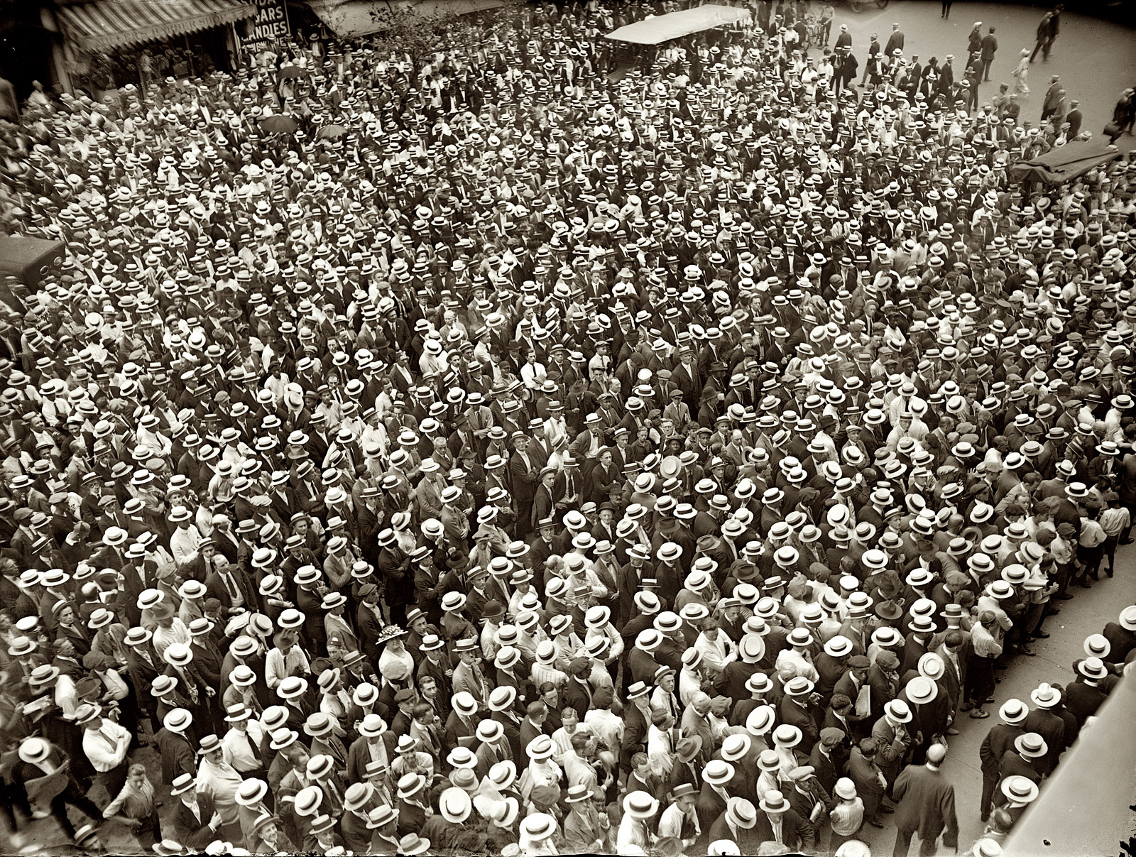 July 2, 1921. Another view of those straw-hatted boxing fans following the Dempsey-Carpentier fight from the Washington Star building in Washington, D.C. View full size. National Photo Company Collection glass negative.