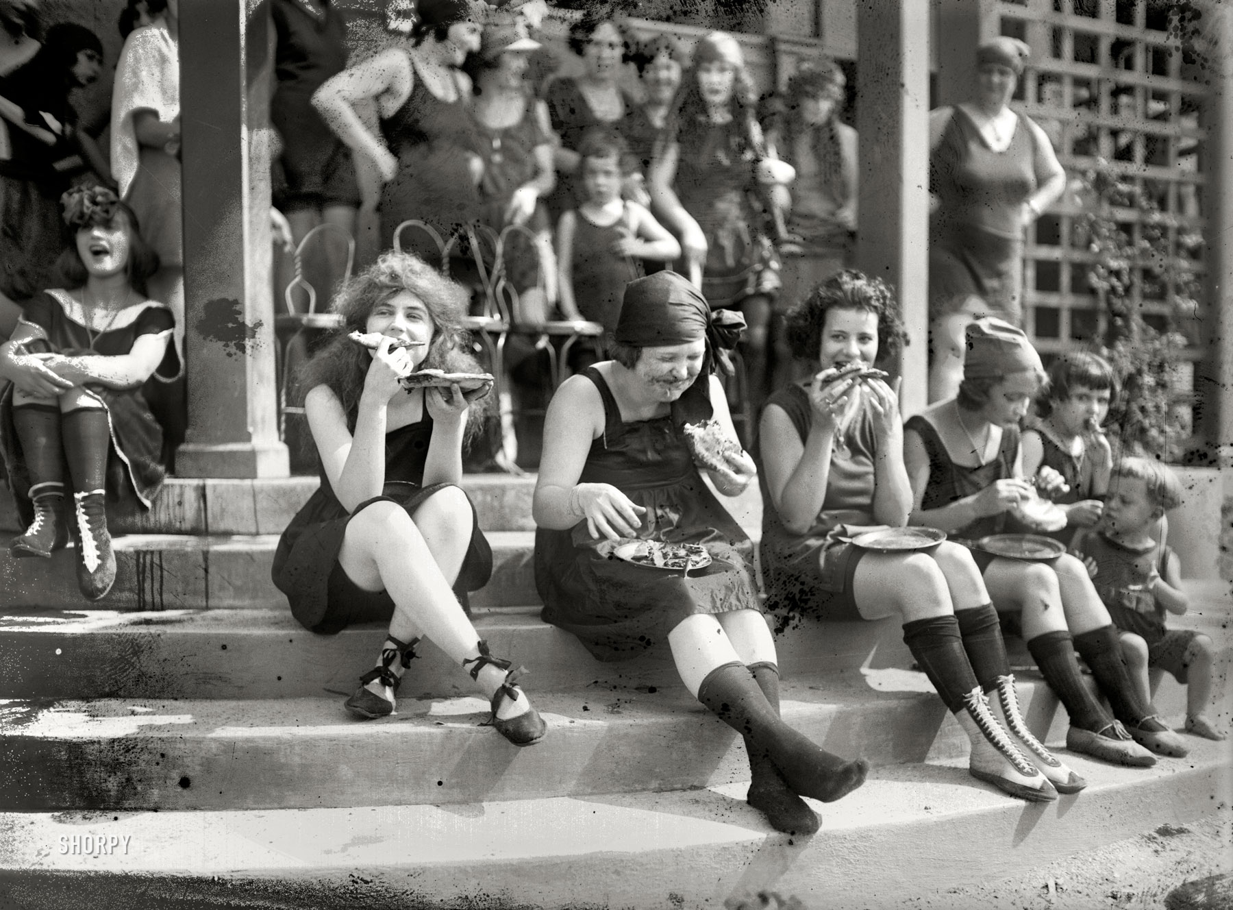 July 31, 1921. Washington, D.C. "Pie eating contest at Tidal Basin bathing beach." In the back row: the blurry but unmistakable facial contours of Iola Swinnerton. National Photo Company Collection glass negative. View full size.