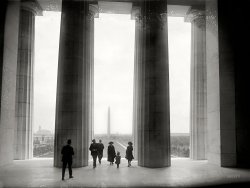 May 5, 1922. Washington, D.C. "Vista of Monument from Lincoln Memorial." National Photo Company Collection glass negative. View full size.
Brand new and timelessThis photo was taken shortly before the dedication of the Memorial on May 30, 1922. Robert Lincoln (79) was there.
The Reflecting Pool is not yet in place, though it was part of the original design and was finished the next year. Ironically, if you go to the Memorial today, you'll find bare dirt again while the pool is being renovated.
The buildings glimpsed to the left along Constitution Avenue. are no longer there; from the same vantage point today you would see part the Vietnam Veterans Memorial. Still, if there's a timeless vista anywhere in the United States, this is it.
Timeless, IndeedIf there's ever a listing of the top 100 photos ever taken this must be on that list.  Thank you.
Speaking of the Reflecting PoolIsn't that where -- oh my God! -- they killed Kenny?
Main NavyThe buildings along the left (north) side of the Mall are the "Main Navy and Munitions" buildings. Built as temporary quarters for the Department of the Navy and the Department of War in 1917, they were torn down in 1970.
The Old Post Office tower is behind them.
Into the MistOn a warm October evening in 1992, I sat with a girl on the top steps right in front of the columns on the left, and looked down the long vista of the Mall, with the Reflecting Pool in the foreground, the Washington Monument glowing behind it, the beautifully lit dome of the Capitol in the far distance, and a big, full moon hanging overhead.  She was from California and had never seen any of this before.  After a few moments of quiet, she said simply, "Thank you for showing me this."  And my heart was hers.
I'd relive that moment in a heartbeat.
How do you delete a comment?How do you delete a comment?
(The Gallery, D.C., Natl Photo)