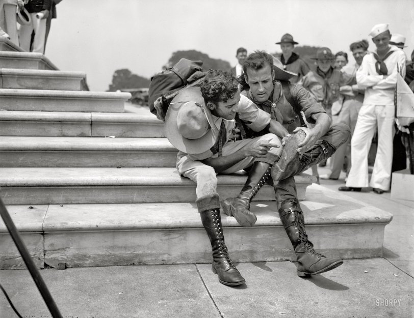 June 16, 1937. "Walk 800 miles to attend Boy Scout Jamboree. Two Venezuelan Boy Scouts, Rafael Angel Petit, left, and Juan Carmona, examining their boots after tramping 25 miles a day for two years in order to attend the Boy Scout Jamboree in Washington. They left Caracas Jan. 11, 1935, arriving in Washington today." Harris &amp; Ewing Collection glass negative. View full size.

