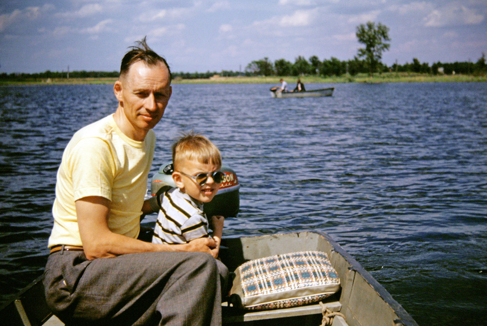 On a fishing trip with my dad, c.1950 somewhere in Minnesota. My dad bought that 2.5 hp Johnson motor from a co-worker at the printing plant where he worked; he sold it back to the same co-worker over 20 years later for exactly what he paid for it, and upgraded to a new 7 hp Johnson. American made. View full size.
