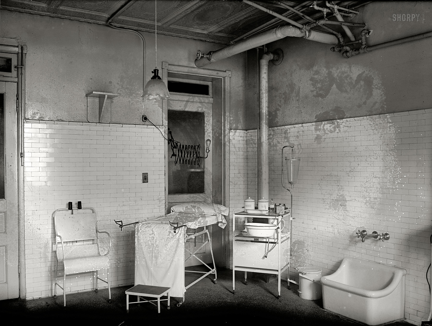 Washington, D.C., 1922. "Social Hygiene exhibit. House of Detention, Women's Bureau. Clinic -- Mental and medical examinations are essential in order to make intelligent disposition of cases." National Photo glass negative. View full size.