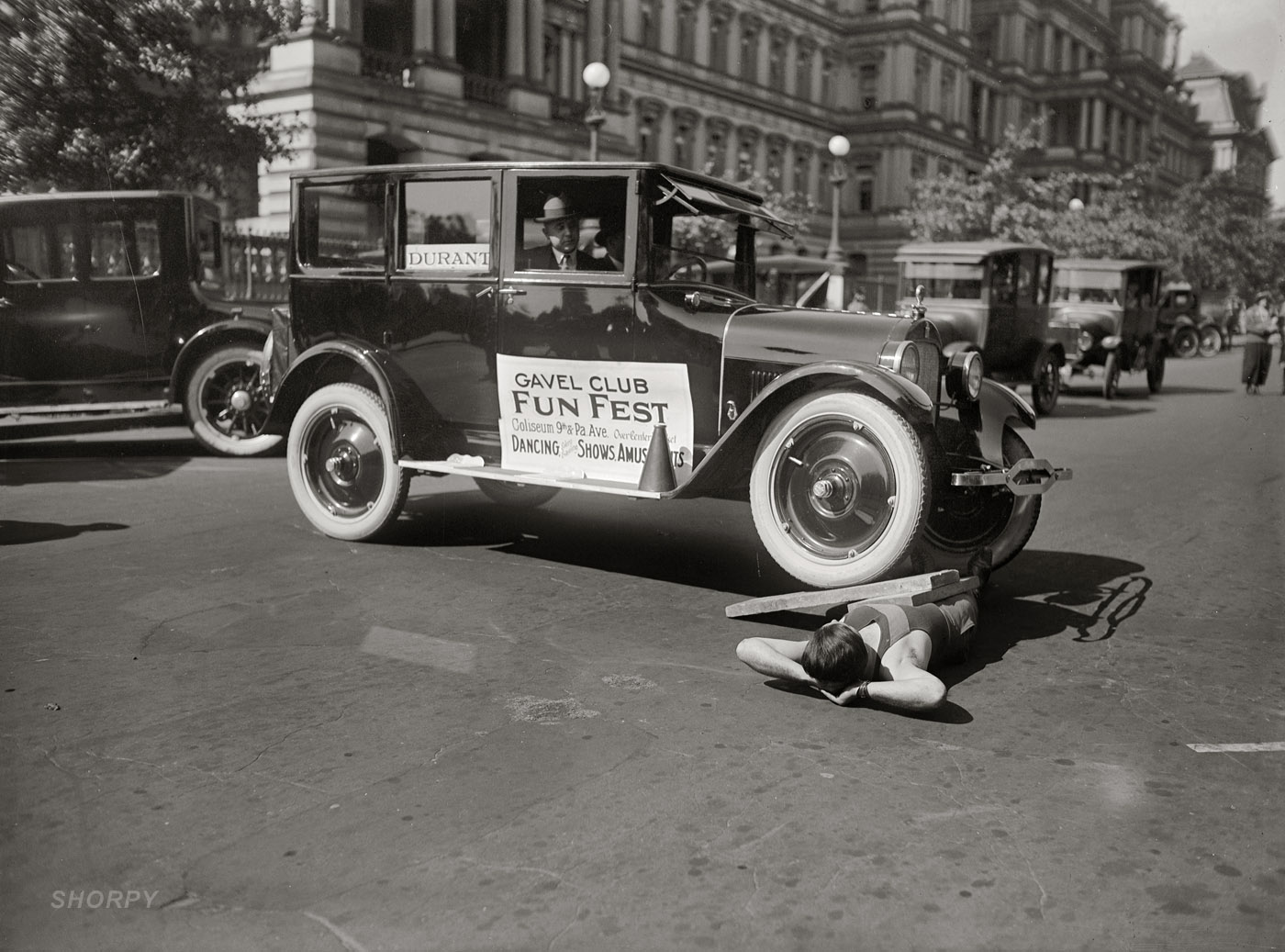 "Galen Gough, October 5, 1923." The Miracle Strong Man under two tons of fun outside the State, War and Navy building in Washington, D.C. National Photo Company Collection glass negative. View full size.