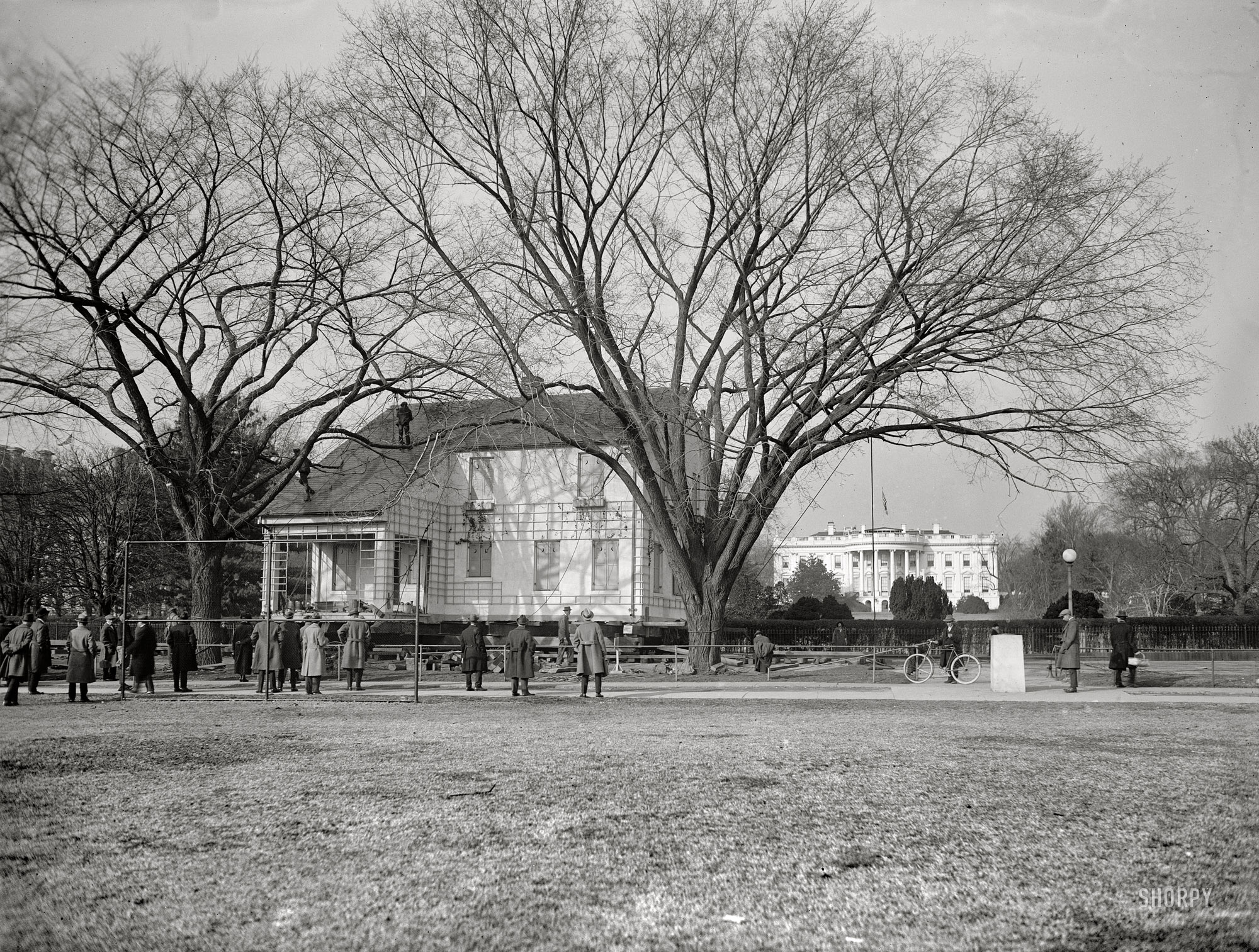 February 2, 1924. "Home Sweet Home being moved to its permanent location, passing the south grounds of the White House. The building is to be used as a headquarters for the Girl Scouts of America." After eight months in Sherman Square the building, a "model American home" put up by the National Federation of Women's Clubs, was moved ("by hefty mules," said the Washington Post) to new digs at 18th Street and New York Avenue. The "snug little house" (weight 150 tons) was a replica of the Long Island residence of lyricist John Howard Payne, who 100 years earlier had written "Home Sweet Home." View full size.