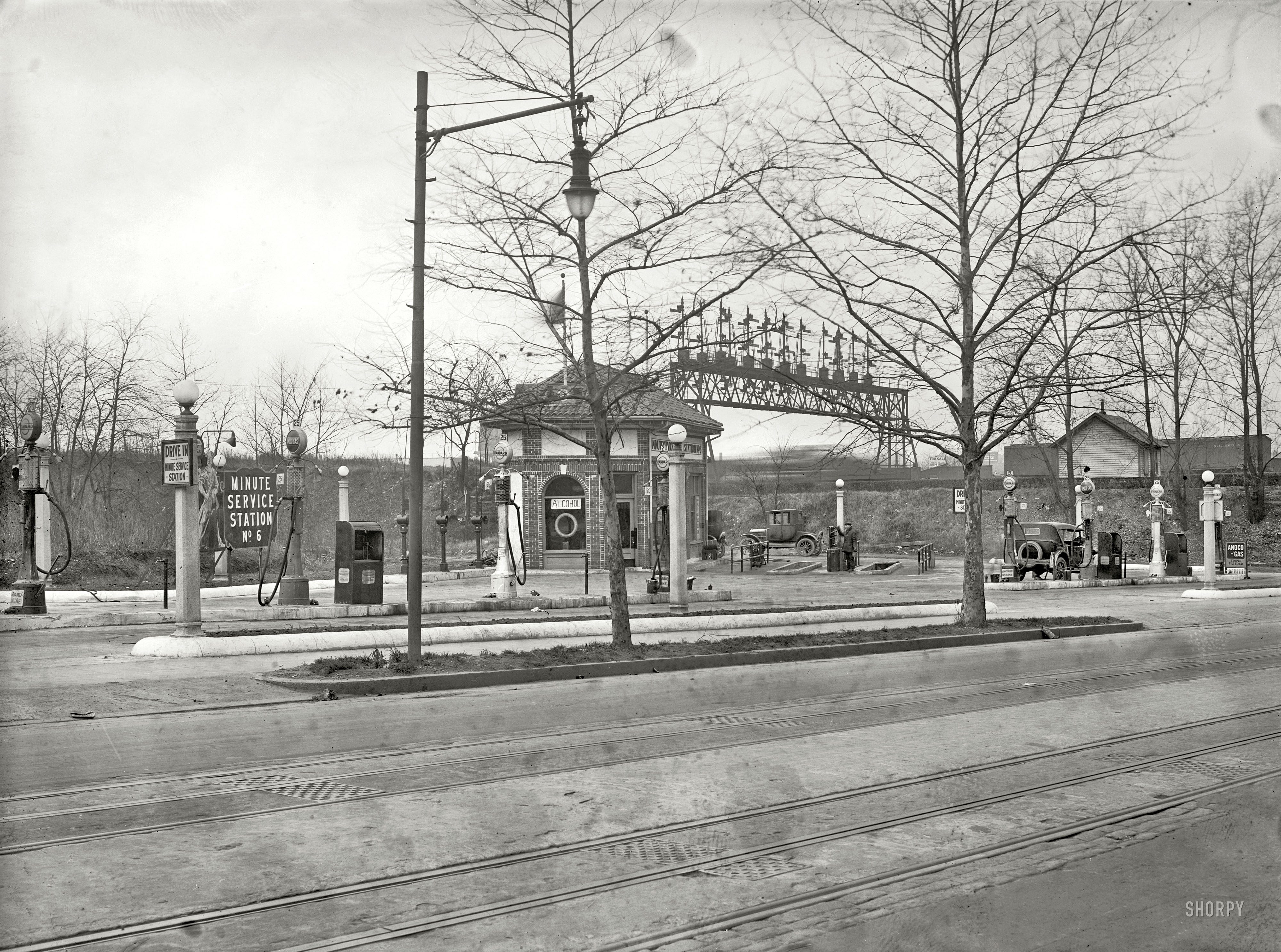 1925. "Texas Co., Third Street & Florida Avenue N.E." One in a series of photos, evidently commissioned by Texaco, of service stations in and around Washington, D.C. Here we have the added attraction of a speeding train. View full size.