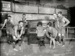 Feb. 15, 1926. Washington, D.C. "Palace team, entry in the American basketball league, being taught Charleston by Vivian Marinelli. Left to right: Kearns, Manager Kennedy, Conway, woman playing piano, Miss Marinelli, Grody, and Saunders." National Photo Company Collection glass negative. View full size.