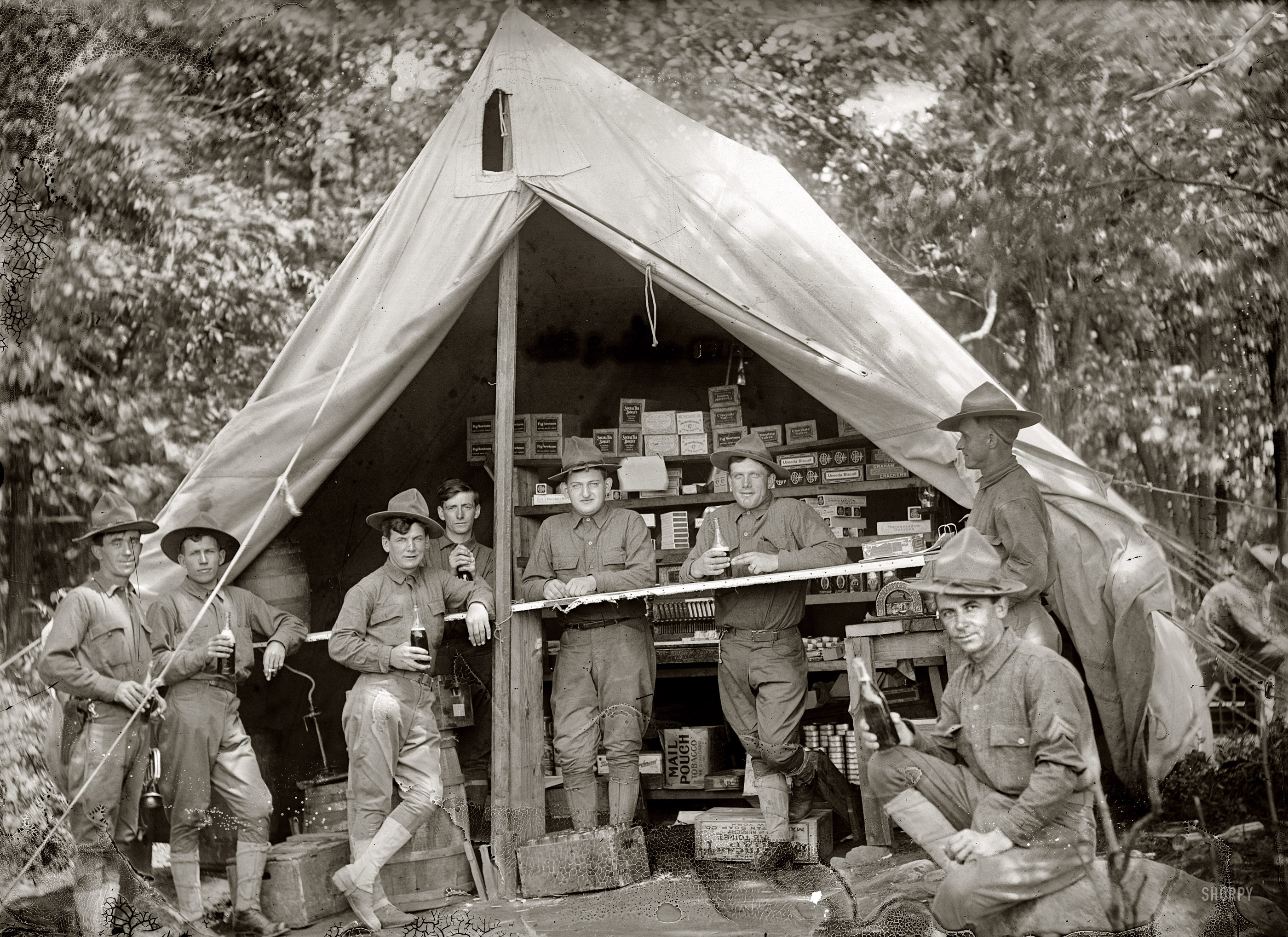 Circa 1914. "U.S. Army or National Guard." Among the comestibles behind the cash register: Fig Newtons, Social Tea Biscuits and Marshmallow Dainties. National Photo Company Collection glass negative. View full size.