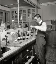Washington, D.C., circa 1920. "U.S. Treasury, Internal Revenue Department." Measuring the alcohol content of various libations and tonics at the start of Prohibition. National Photo Company Collection glass negative. View full size.
Testing for content.I know a way to measure alcohol content without using test tubes. (Buuurp)
How much alcohol?Young man, as you measure the alcohol content in these mysterious "poison" bottles, remember the words of Mae West:  Too much of a good thing is better.
PoisonIt is interesting that four of the bottles being tested have poison labels on them. Were they tonics or were they libations?
[Notes typed on the labels say beer. At first I thought the Poison stickers were a ruse to trick the revenuers. But the bottles are from different sources -- Springfield, Illinois, and Erie, Pennsylvania, to name two. Another label says the contents are a sample taken from a "bottling house." So these might be the agents' standard storage bottles (or labels) for seized booze. - Dave]
Who knew?A young Foster Brooks at his first place of employment.
You shouldn&#039;t blame the Twerp, er, Scientist.Here's your Prohibitionists!
Proofing grounds80 proof beer? I like the sound of that!
Re: PoisonAnother possibility is that the samples were deliberately denatured at the time they were collected, and labeled to prevent them being stolen from the analysts and consumed.
Poison and ProhibitionA very fun read on the subject of elixirs, poisons, perfumes, and alcohol is "The Poisoner's Handbook" by Deborah Blum.  It is somewhat mis-titled, since there is a long section on the NYC medical examiner's office and problems associated with Prohibition.  I was surprised to read about the escalating "arms race" between the federal government's development of various poisonous compounds added to denature so called "industrial alcohol," intended to discourage human consumption, and the bootleggers' effort to remove these poisons by redistilling alcohol containing liquids, such as perfume.  Apparently this is a longstanding practice related to taxation.  During Prohibition, it became a significant public health issue.  The poisons that were added to denature drinking alcohol, which were mandated federal formulas and often contained other highly toxic substances besides just methyl alcohol, apparently injured and killed many people, and became quite a controversy.  I didn't know much about the subject, and so it was quite a fascinating read.
Hazardous to your health?Not so much the alcohol but the acids and other concoctions used to do their testing. Those faucets and taps look decidedly corroded by some of the chemicals.
Make mine &quot;up&quot;With an olive, please!
BureaucratsLook at that pencil-necked twerp!  He was probably the kid in school who was always tattling on the other students.
(The Gallery, D.C., Natl Photo)