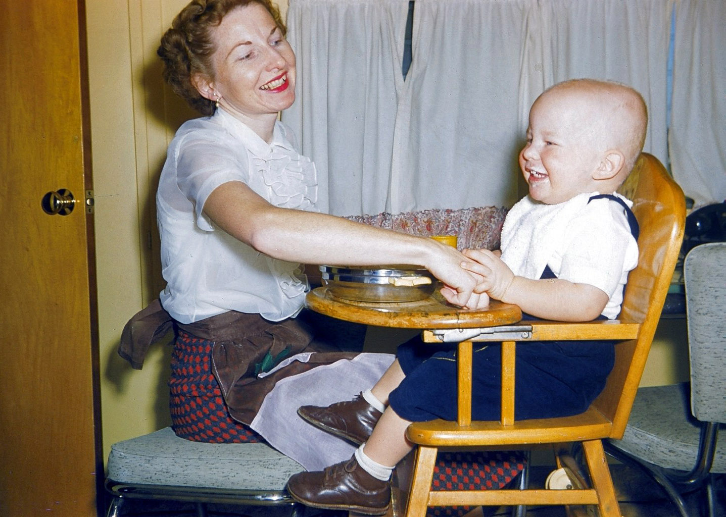 This is my first picture here at Shorpy. What a great place. This is not posed. It looks like a baby food ad, but my Dad caught us in a great moment. My beloved Mom and me in 1956 in our home in West Covina, California. We lived there until I was 9. Mom is still with us at age 83. View full size.