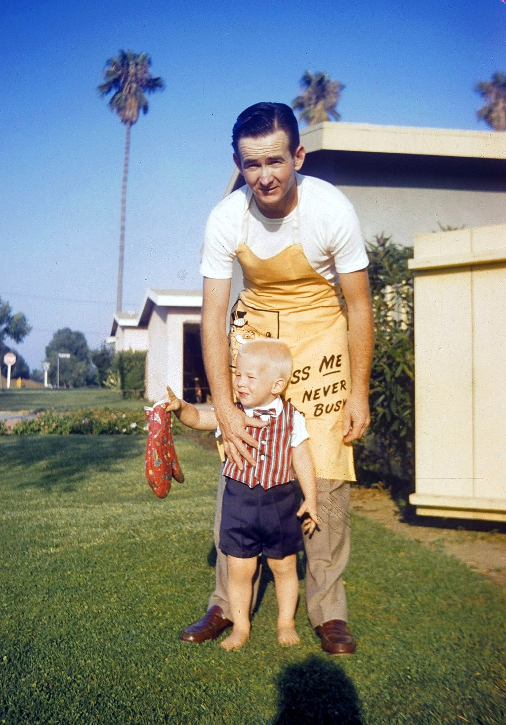 Daddy taking a break from the BBQ in West Covina, California, circa 1957. Mother took the picture and you can see her shadow. West Covina was one of the new suburbs east of Los Angeles back in the nifty 50s. Dad was a decorated combat veteran from the Korean War, and used his VA benefits to buy two homes. This was the first. This was a great place. I had wonderful friends and neighbors. My folks have often said this was the best place they have ever lived. Neighbors were friendly and they socialized with each other. There was an air raid siren nearby that went off twice a month as a test. This was the height of the cold war, but what did we know. View full size.