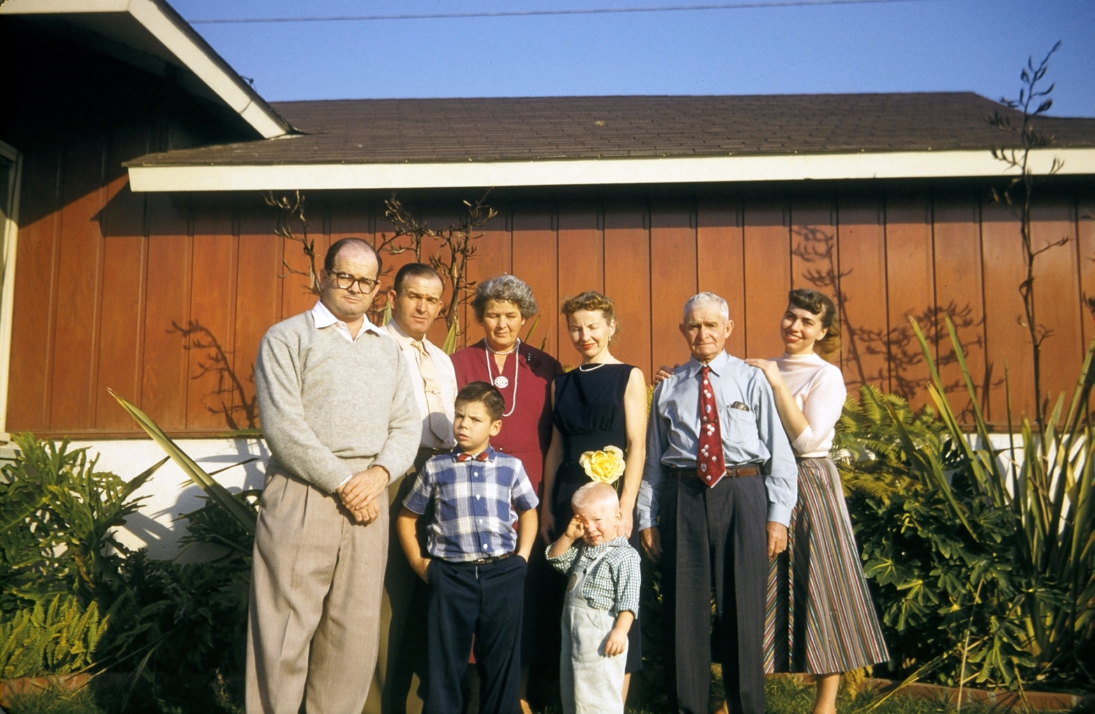 This was taken at my uncle's house near Venice Beach, California. I was about 3, so this would be 1958. From the left, my uncle (Dad's brother), a biochemist of some renown; Dad's other brother; their mom; my mom (squinting in the sun); my granddad (father of the two guys on the left); and last but not least, my aunt (wife of the biochemist), who was one of the finest people I knew. I do not know what became of her after the early '70s. Finally, the boys. The bigger one eventually became really wealthy, an owner of a professional sports team, and had legal trouble. The smaller one is yours truly, squinting like his mom! This was taken at a time when my little extended family was not only alive but still functional. As usual, the cameraman was Dad! Back then, he had a 35mm camera he bought in Japan on leave from fighting in Korea. Some of these peeps have appeared in my Christmastime pictures, posted earlier. Enjoy. View full size.