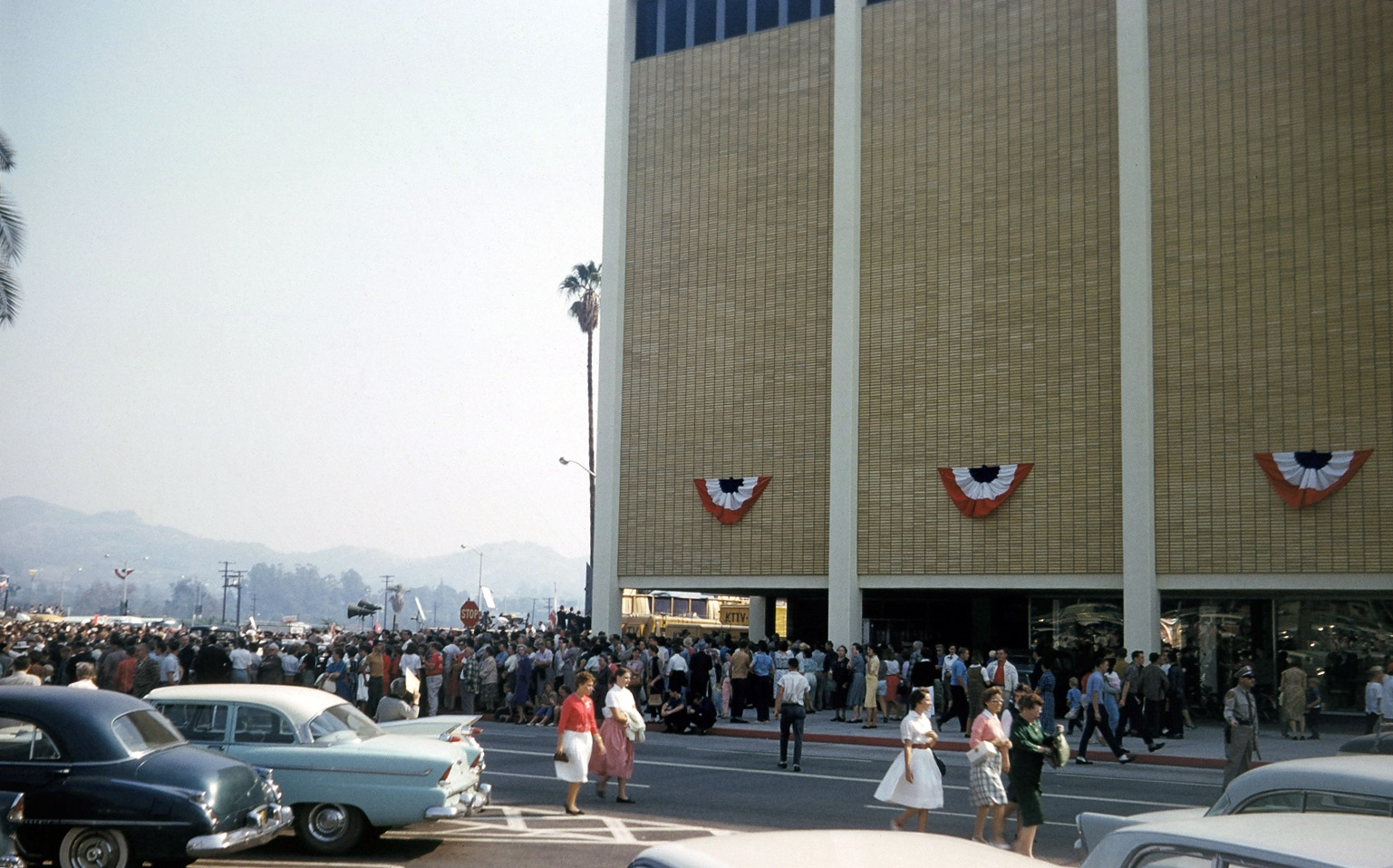 West Covina, California, 1960. My mother rushed me and my next door pal Dennis to the Eastland Shopping Center to hear Richard Nixon on his Presidential campaign swing through Southern California. The big store shown is May Company. When I was a teenager with a job, I bought my school clothes there. This would be 12 or 13 years later. Eastland is there today, looking quite different! Here's another post of Dennis and me on the hood of my mom's car at this event. View full size.
