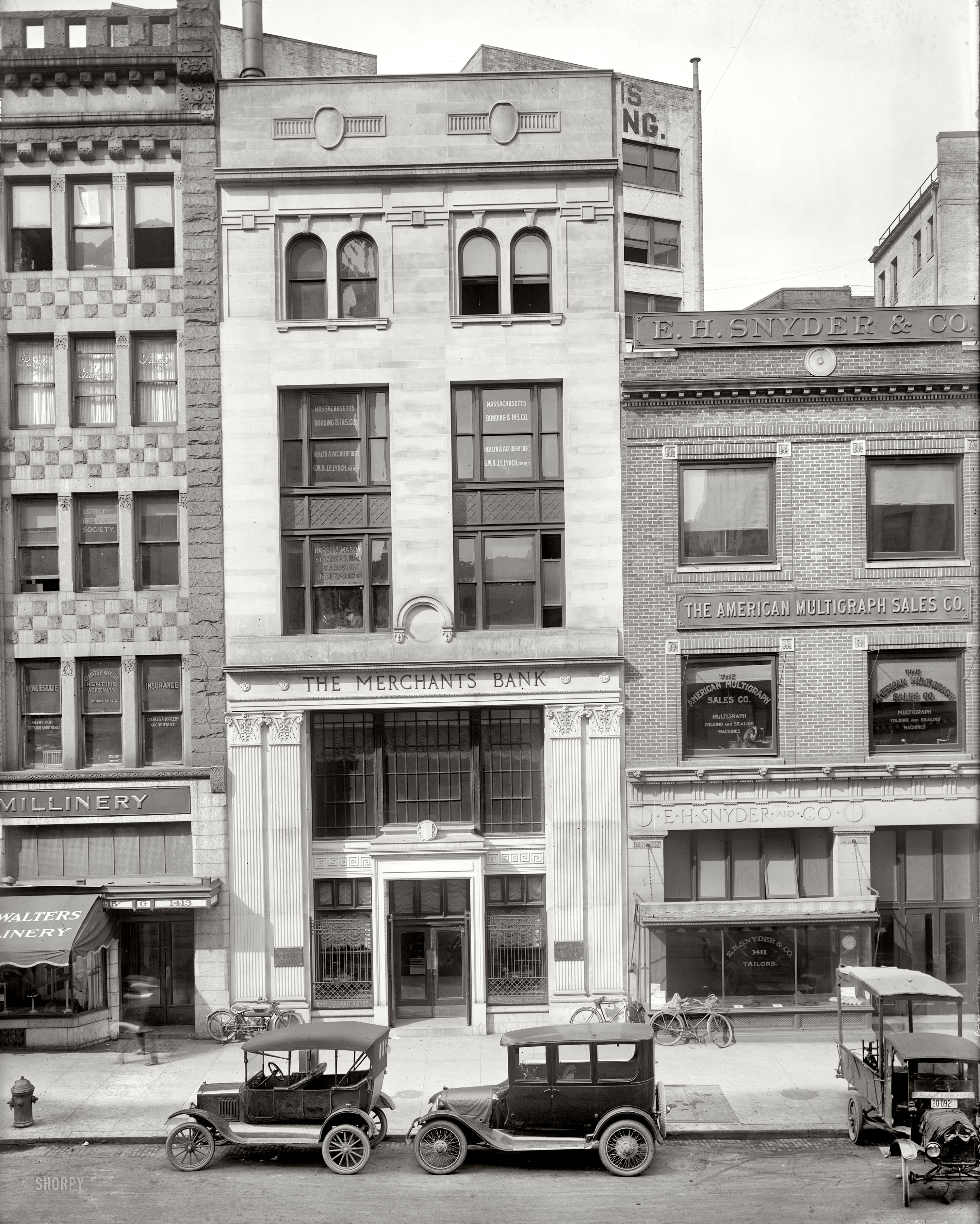 Washington, D.C., circa 1920. "Merchants Bank, G Street N.W." What looks at first like a fairly desolate street scene turns out to have a number of players. National Photo Company Collection glass negative. View full size.