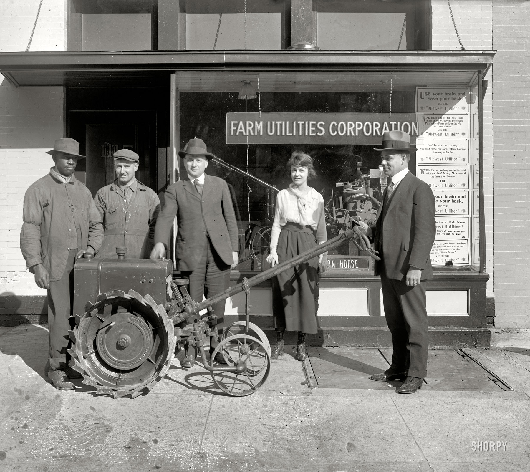 Washington, D.C., circa 1920. "Farm Utilities Corp. (exterior), 14th Street N.W." The two three draws here, for me at least, are the amused expressions of all concerned, and the name of this particular piece of equipment: "Midwest Utilitor." Oh, and the entertaining signage in the window. National Photo. View full size.