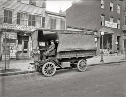 Washington, D.C., circa 1920. "O.J. DeMoll Co., Autocar truck." The cigar store has an interesting selection of magazines, including one called Saucy Stories. Mold-spotted National Photo Company glass negative. View full size.
The BillboardThat Billboard magazine in the window would come as a shock to someone reading it today as it *gasp* didn't include any music charts! The first hit parade wasn't published by the magazine until 1936. Instead readers were likely to find reviews of motion pictures and live events, as well as listings of upcoming shows.
[Subtitle on the cover is "A Weekly Theatrical Digest." - Dave]
Saucy StoriesAccording to the Magazine Data website (philsp.com) Saucy Stories was founded by H.L. Mencken and George Jean Nathan in 1916, then sold by them within in a year.  I am surprised that this was displayed in the window as I have always thought of this type of pulp as being an under the counter item.  As a pulp magazine fan I would love to see a close up of the magazines.
[Click the first link in the caption for a closeup. - Dave]
O.J. DeMoll &amp; Co.The photo is at 12th and H streets northwest.  The July 24, 1919 Post reports that the Howard P. Foley Company is remodeling the building at 806 12th street for use as a store and office building.



(click for larger version)

BillboardThough Billboard is primarily known as a music magazine, it predates the rise of the record industry. It began as a trade publication for advance men (theater, music, even circuses) who went town to town posting bills to publicize upcoming entertainment events.
Dedicated coverage of music and music sales came much later, through the connection that a touring musician had advance men, as well as a vaudeville or comedy, or theater troupe. But early Billboard was about touring road shows and the people who worked behind the scenes to publicize those.
PricesWe often see the prices and think nostalgically of the old days.
Well, look at some of the prices listed here. Songs rolls for $1 - which in today's money would be $12. Even  if you buy music now (and seemingly fewer and fewer do), we pay a dollar a song on iTunes.
But, how about a new Aeolian-Vocalion for $2000! That would be around $25,000 in present day dollars.

Saucy, Not SpicyMost of the stories in Saucy Stories were much like those in Captain Billy Fawcett's Whiz Bang. Most of it was on the order of "He drinks to calm himself. Last night he got so calm he couldn't move." 
In all probability, that Billboard had ads for various acts and actors that could afford advertising, the "pipes for pitchmen,"  ads for novelties, "slum," carnival routes, and other items relevant to amusement business generally. 
It might interest some to know that at that time, a concessionaire generally paid 5 percent of their gross to the venue. Today that's as much as 70 percent. No wonder hot dogs are so expensive at the state fair.
Old Radio Man
Popular MechanicsThat issue of Popular Mechanics at the bottom of the narrow rack is from March 1920.  The cover features an elephant carrying a motorcycle.

Why the Bulletin?The newspaper covering one of the doors appears to be the Bulletin, an afternoon daily published in Philadelphia (and, in this instance, reporting on the progress toward ratification of the Ninteenth Amendment).  With the headquarters of both the evening Star and the morning Post a few blocks away, the choice of the Bulletin seems odd.
[I'd imagine there were dozens of newspapers called the Bulletin. This particular "Bulletin" seems to be a page of Washington theater listings. - Dave]
VocalionThey needed a huge truck to deliver piano rolls?
[Vocalion was also a brand of Aeolian phonograph (and later, record label). DeMoll was a big dealer in player pianos and Aeolian phonographs (its 12th Street showroom was named Aeolian Hall). Click below to enlarge. - Dave]

Autocar truckSome interesting items to note. This is one of the first cab-over-engine trucks. It also has a front bumper, hand crank, and leather crank holder. Note the tarp that rolls down for the windshield, with the two celluloid panels for viewing. Also the side curtains, rolled up on the camera side. The truck has two side lamps, no headlamps, and solid rubber tires. Brakes at the rear only. Year of the truck is about 1912.
System Magazine"System" magazine--anyone know what topics it covered?
["The Magazine of Business." - Dave]

It&#039;s a jungle out thereEdgar Rice Burroughs, creator of Tarzan, wrote for System Magazine.  He was turned off by the fact that writers like him, with no business experience, were supposed to provide advice to business managers in the journal.  He began sending stories out to be published, first science fiction stories, then the Tarzan stories, in order to be able to leave the magazine and make it as a writer on his own.
Autocar PricesThis Autocar motor truck sold for $2325 ($2150 for chassis only) - not much more than the highest priced Vocalion.  Photo and all the specs are in the 1912 Official Handbook of Automobiles - page forward and back for other Autocar models.
Victor, Columbia, Edison, VocalionThe Vocalion brand name started out in the pre-World War One player piano era, and lasted all the way into the late 1930's.
As it went along, the company made the transition from piano rolls to distinctive red shellac records (with a quite beautiful Gothic-style, multicolored, lithographed label), to what were called "race" records (aimed at the emerging African-American market).
By the late 30's, Vocalion was recording everything from novelty groups like the Hoosier Hot Shots to the immortal, haunting Delta blues of Robert Johnson. There seems to have been one, consistent policy in
force at the label: "Maybe it's obscure, but if it's good, we'll issue it." 
Vocalion Records finally disappeared in the buyout of its parent company, the American Record Corporation, by CBS in 1939. However, many of its best recordings were reissued on the Columbia label, as a result, and continued to sell.
All-Story WeeklyThe All-Story Weekly in the middle on the right is the March 6, 1920, issue.

Grandma&#039;s DeMollMy grandmother had an O.J. DeMoll upright piano in her home in the Anacostia section of Washington. After she died we inherited it. Unfortunately, the movers bounced it around, shifting the harp and soundboard. The piano wasn't worth much, so it was eventually hauled away. We still have the stool that went with it -- it is now a rather nice plant stand.  
I wonder if that truck delivered our old piano to my grandmother's house.
System magazineSystem Magazine was published and edited out of 151 Wabash Ave, Chicago, by Arch W. Shaw (b. Michigan 1876, d. 1962), one of the preeminent business book publishers from 1910 to 1930. Helped Harvard (where he taught now and again) get its Business Review magazine going in 1922. Also a partner in the Kellogg Company.
The magazine became Business Week in 1929.
Shadowland magazineWhat caught my eye in the magazine rack close-up is the Shadowland Magazine. I've googled this but have only come across worn copies being sold on eBay or old magazine sites that have a lot of missing web pages. I was wondering if someone could perhaps point me in the right direction for this particular magazine. I'm a big fan of old photographs, publications, music, architecture, and culture (and subculture).
[Try Alibris.com - Dave]
(The Gallery, Cars, Trucks, Buses, D.C., Natl Photo)