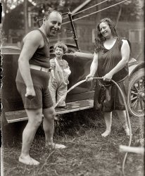 Arthur Fields, singer and composer ("Abba Dabba Honeymoon"), and family washing their Stutz in 1919. View full size. George Grantham Bain Collection.