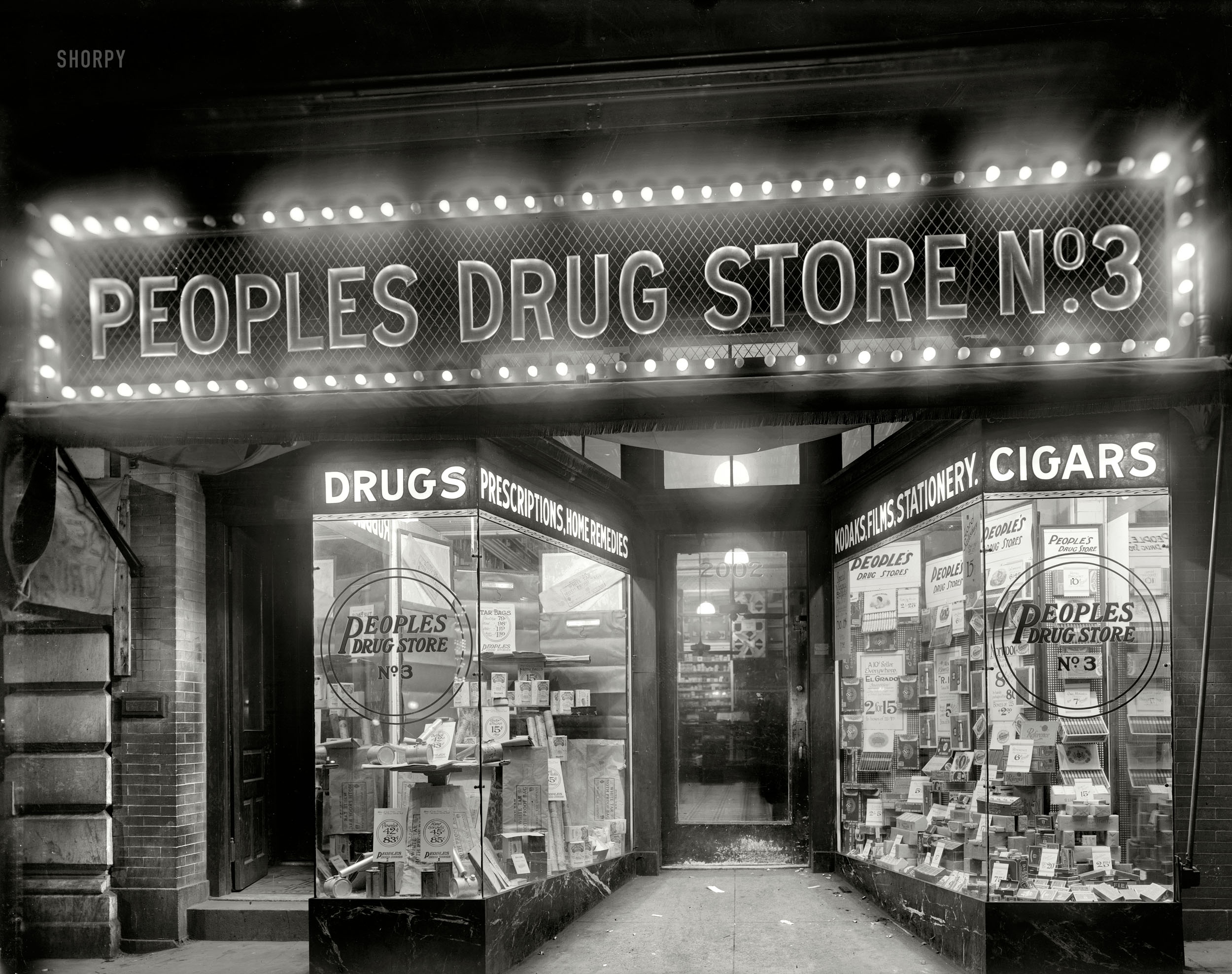 Washington, D.C., circa 1920. "Peoples Drug Store, 14th & U." A nighttime view of the store seen here and here and here. Your headquarters for "tar bags." National Photo Company Collection glass negative. View full size.